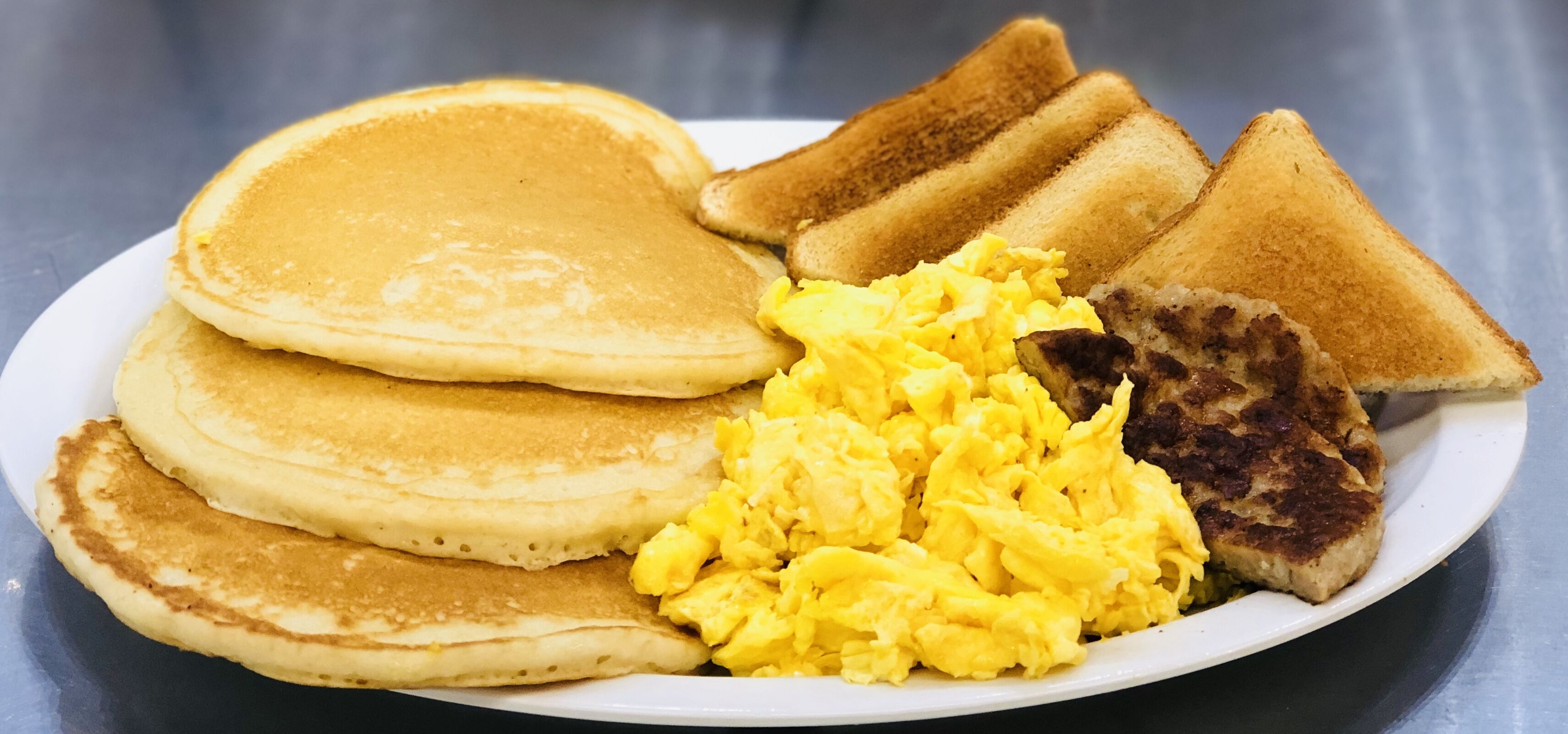 Order #3 Three Pancakes, Eggs and Breakfast Meat food online from 270 Deli NY store, Hempstead on bringmethat.com