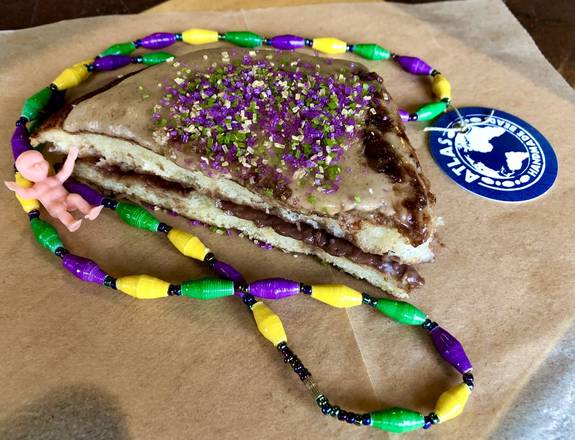 Order Surprise King Cake Slice food online from Breads on Oak Cafe & Bakery store, New Orleans on bringmethat.com