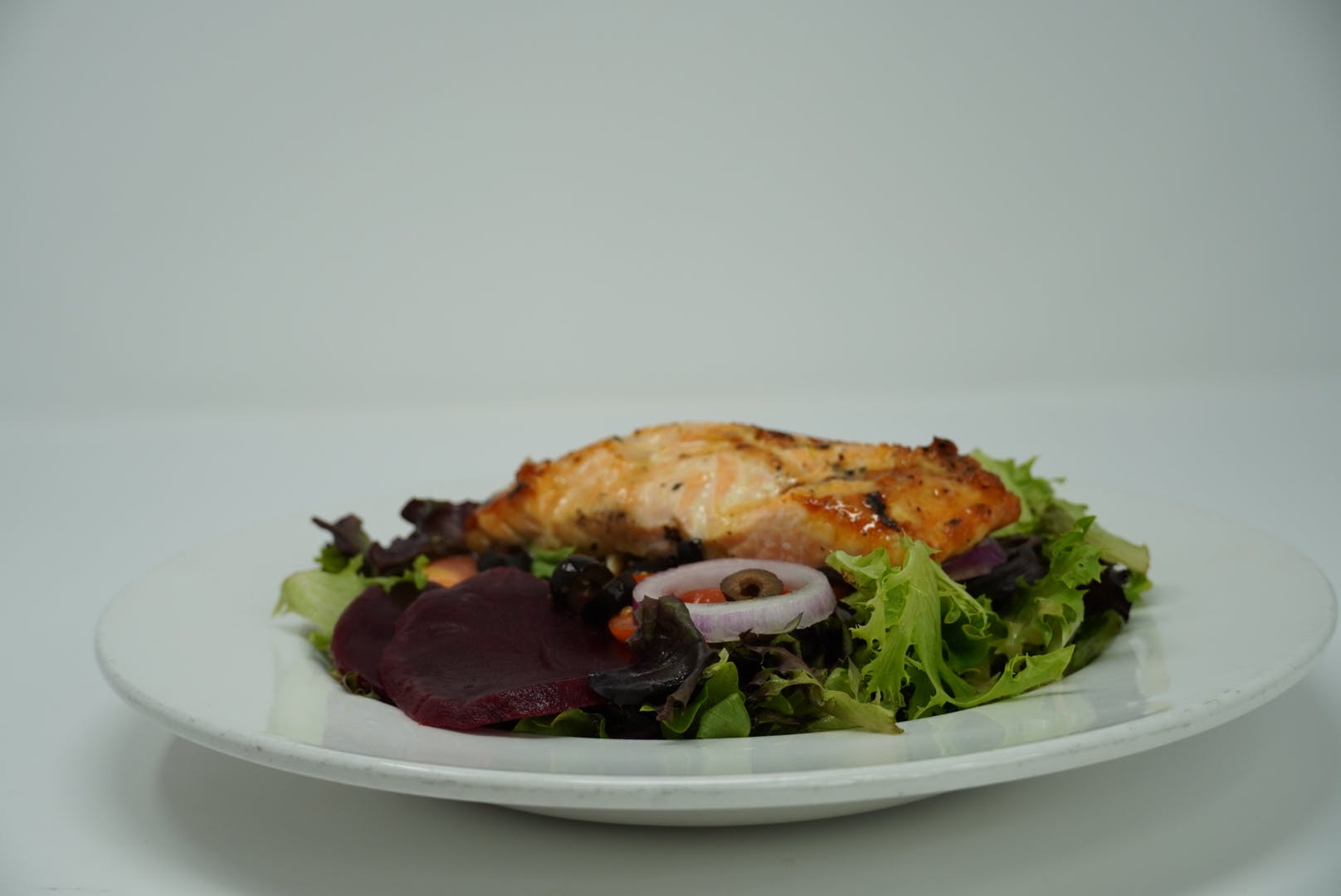 Order Grilled Salmon Salad - Salad food online from DeNunzio's Italian Restaurant - Latrobe store, Latrobe on bringmethat.com