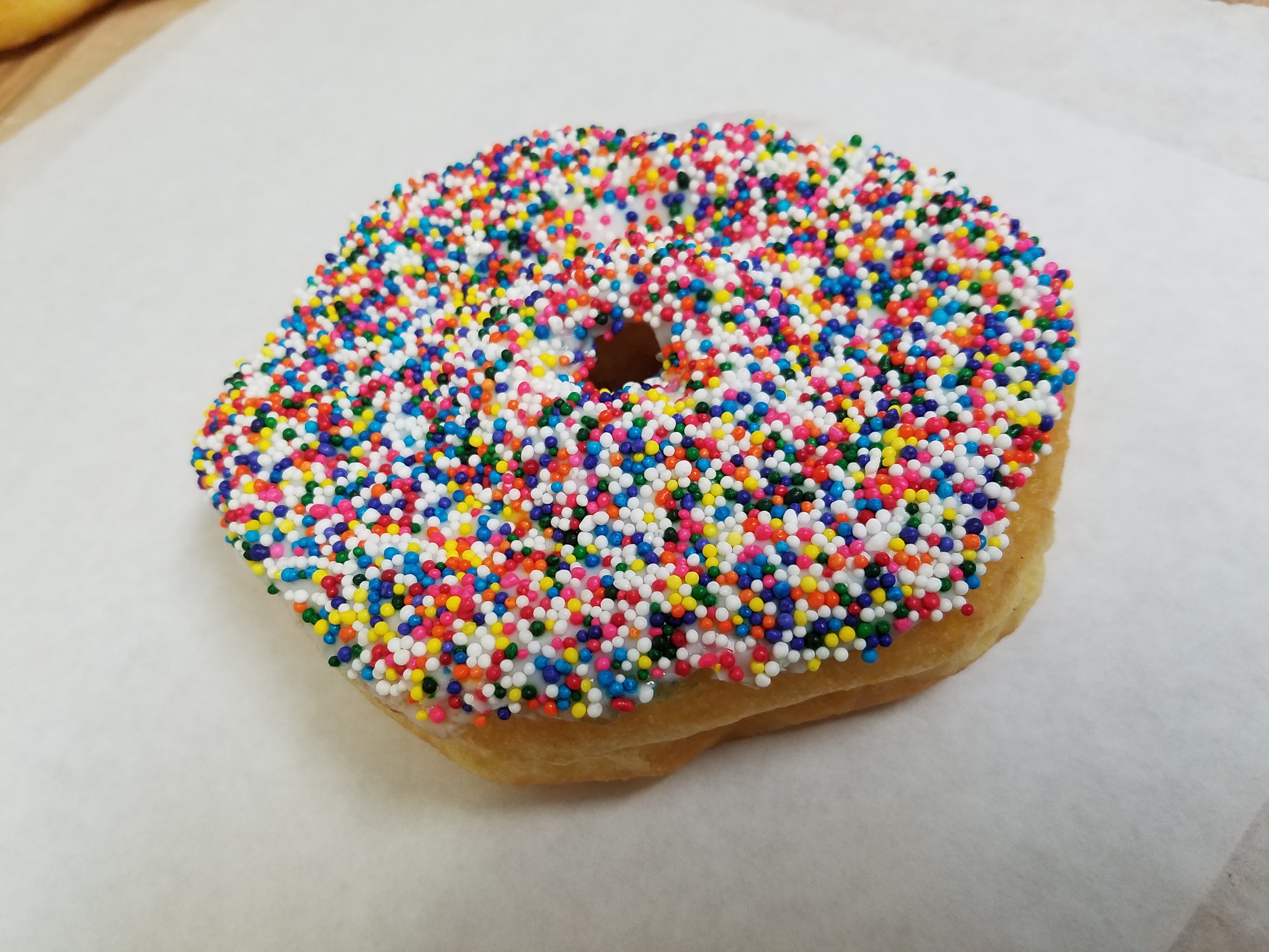 Order White icing sprinkle donut food online from O Donuts store, Everett on bringmethat.com