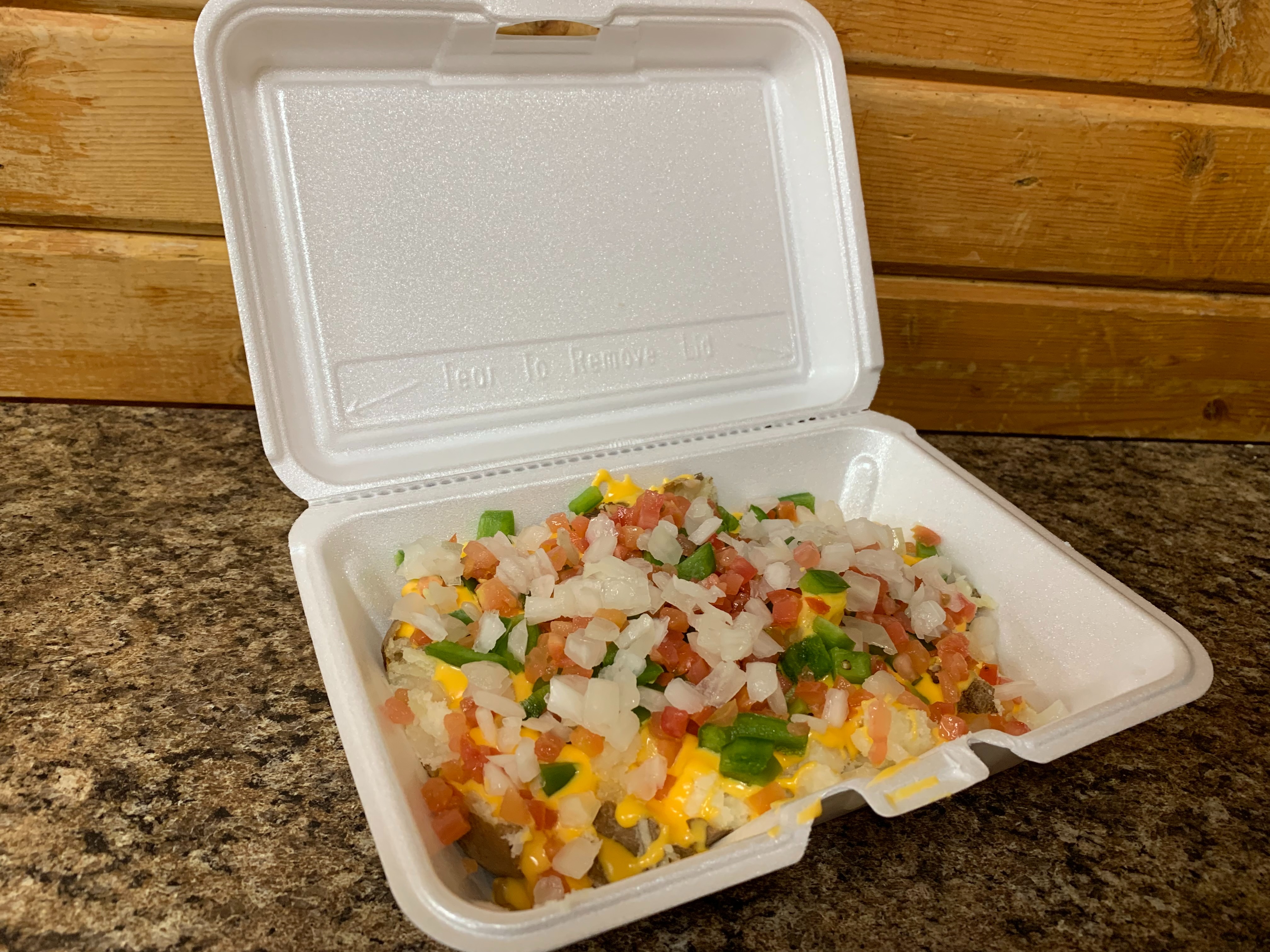 Order 28. Melted Cheddar Cheese, Green Peppers, Onions & Tomatoes Potato food online from Lieber Boxcar Express store, Galesburg on bringmethat.com