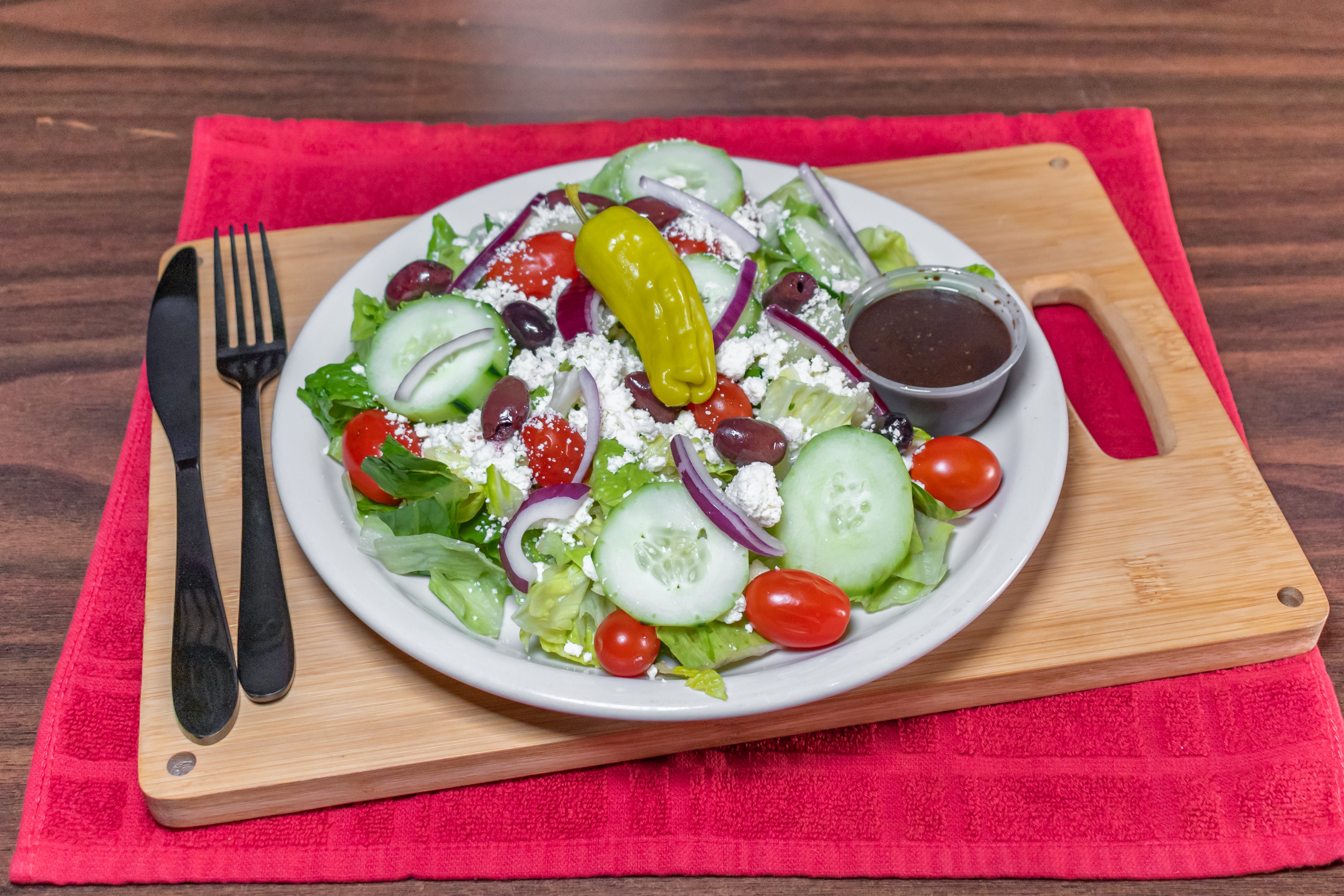 Order Greek Salad - Medium food online from Gotham Pizza store, Houston on bringmethat.com
