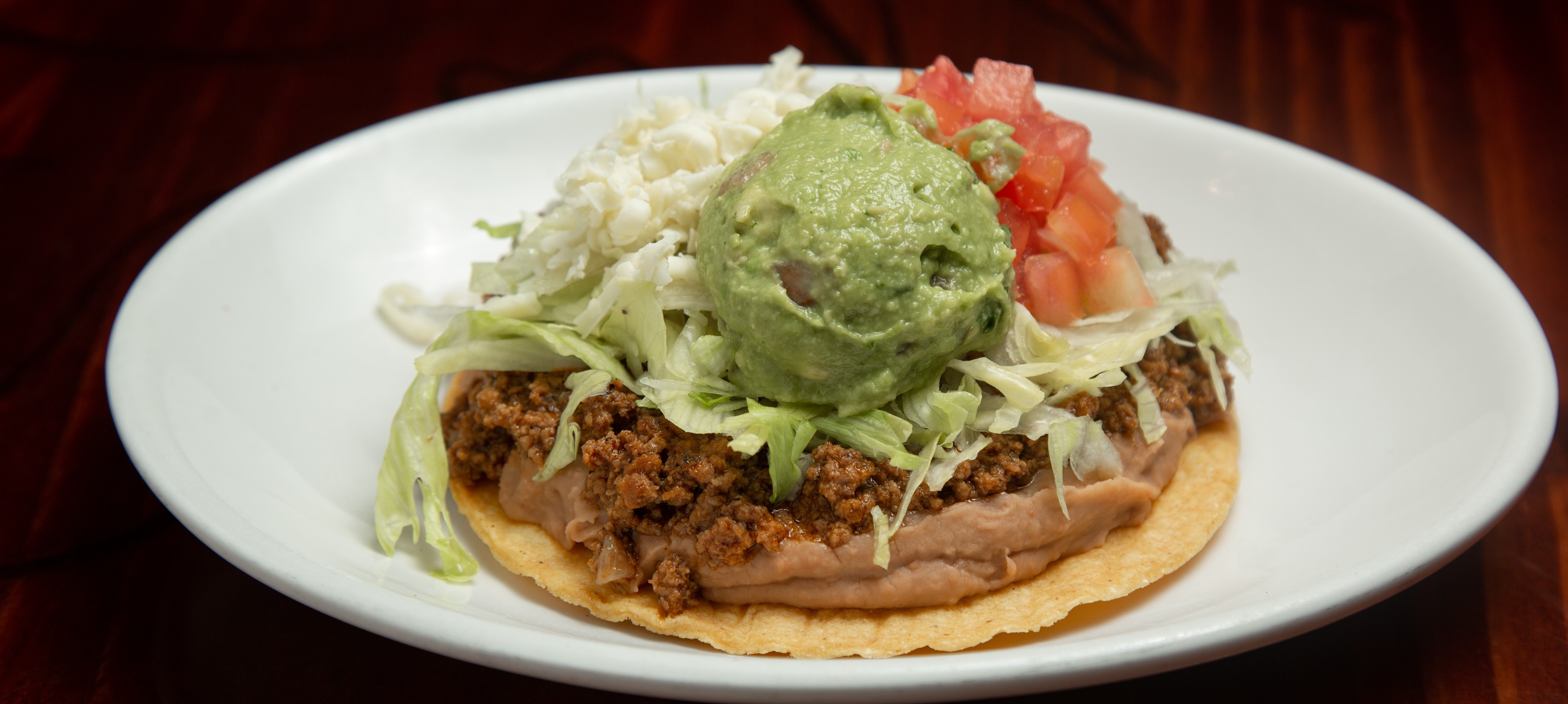 Order Beef Tostada food online from Tito Mexican Restaurant store, Spring Hill on bringmethat.com