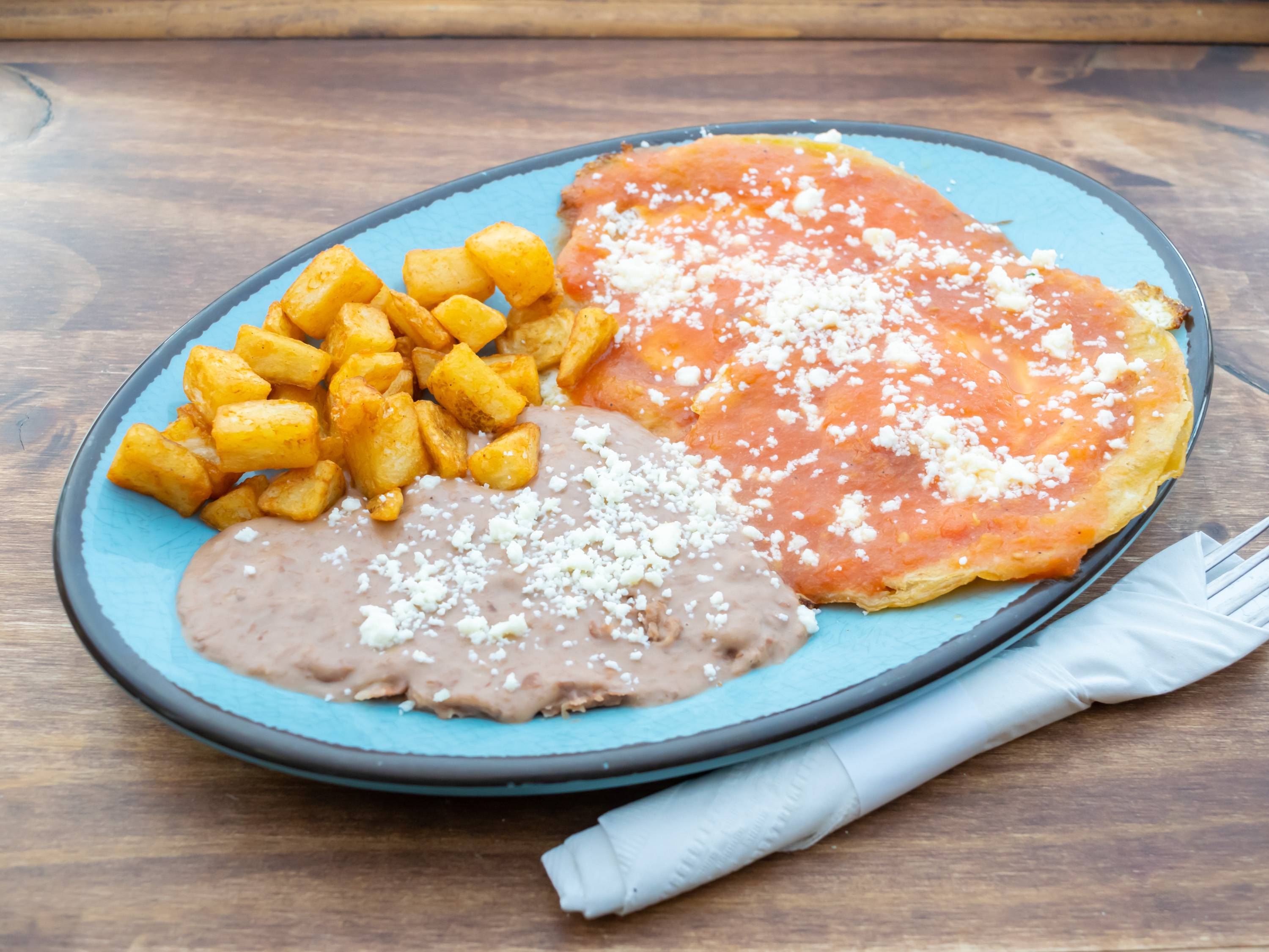 Order Huevos Rancheros food online from La Familia Cafe store, Kalamazoo on bringmethat.com