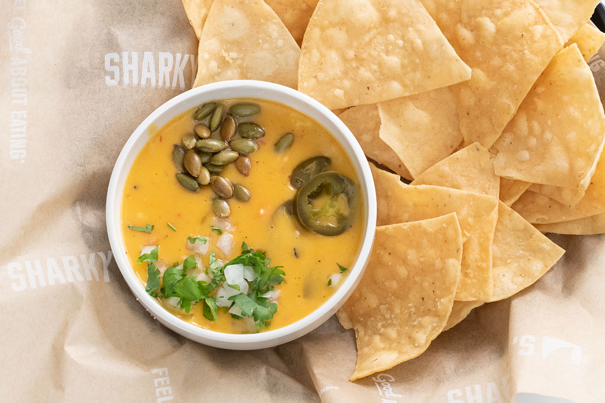 Order Plant Based Queso and Chips food online from Sharky's Woodfired Mexican Grill - Newport Coast store, Newport Coast on bringmethat.com