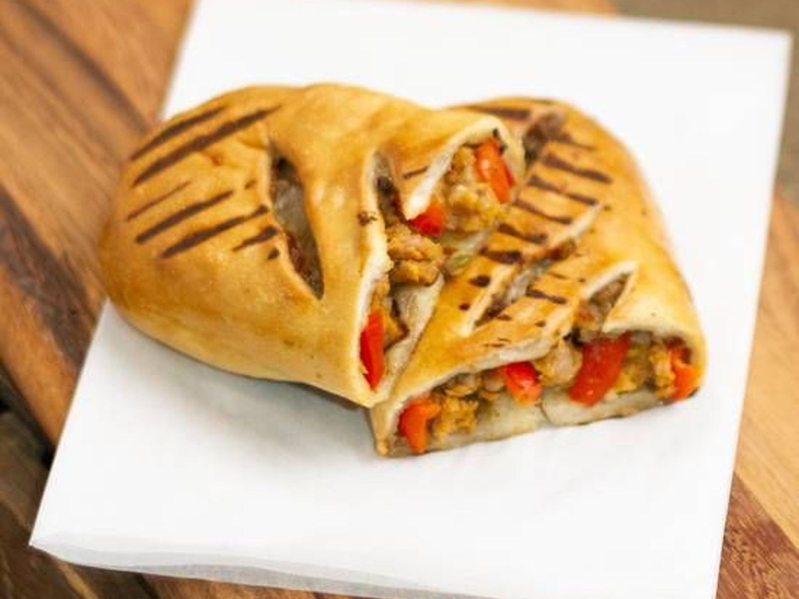 Order Sausage & Roasted Pepper Calzone food online from Caffe Nero store, Melrose on bringmethat.com