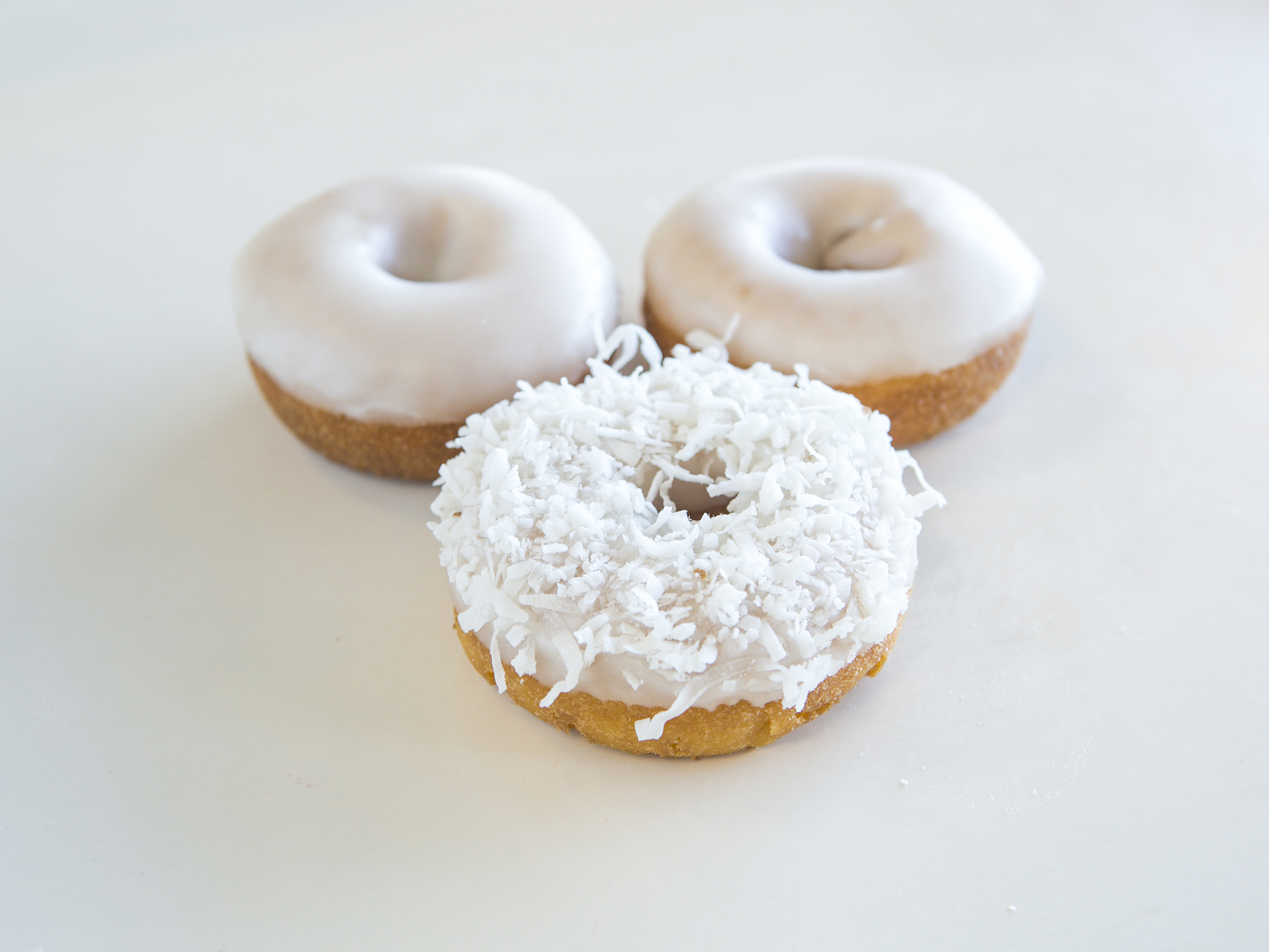Order White Iced Cake Donut food online from Ray's Donuts store, Kansas City on bringmethat.com