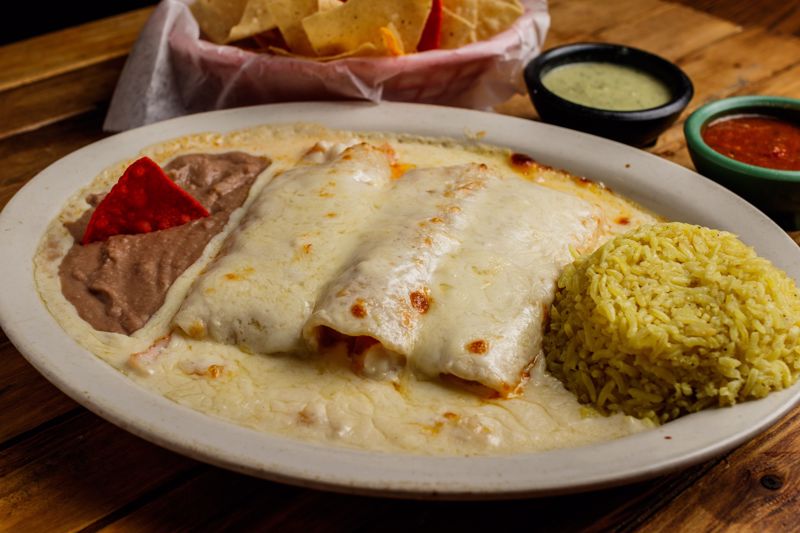 Order Enchilada Suiza (Large) food online from Cilantros Mexican Restaurant store, Houston on bringmethat.com