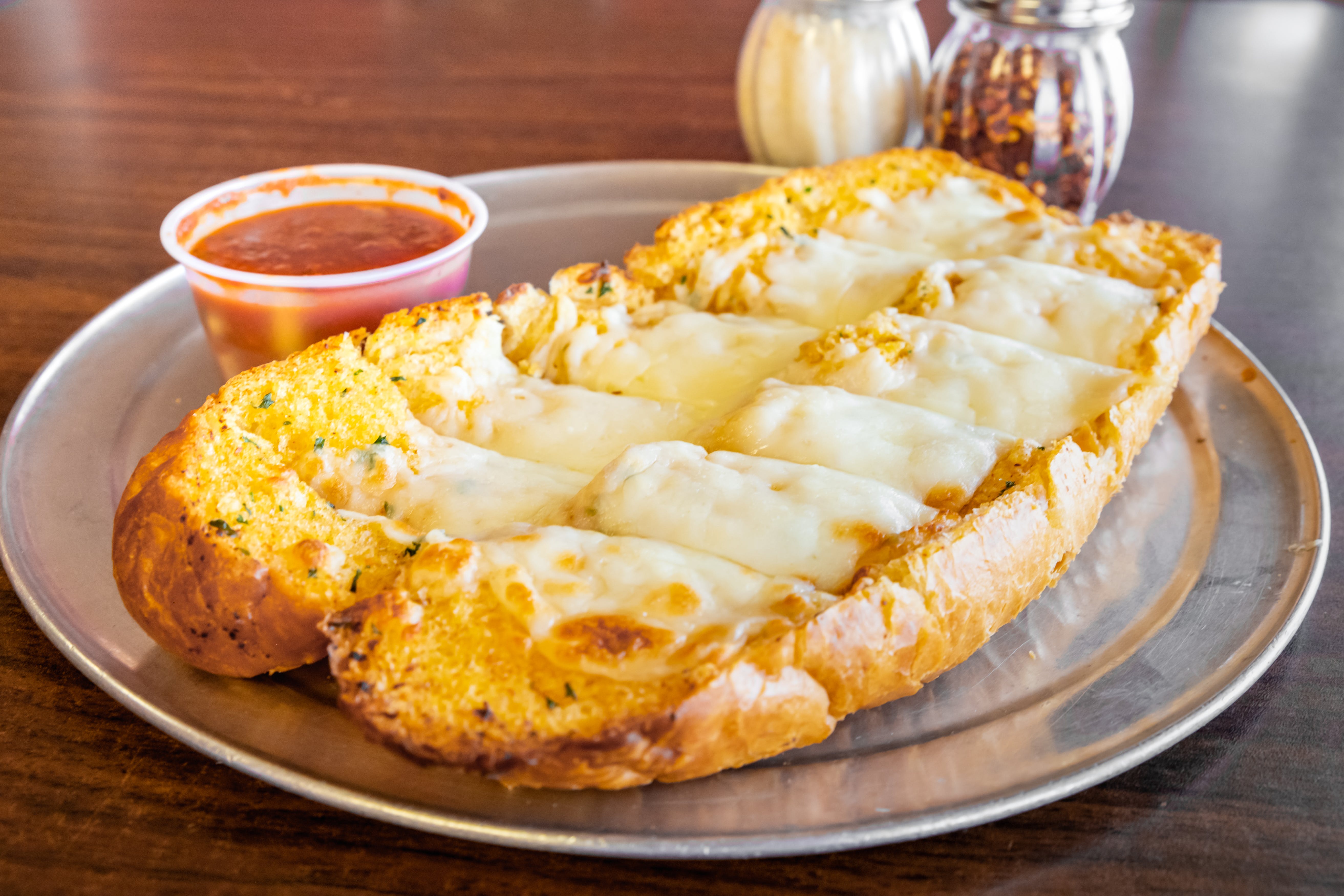 Order Garlic Bread with Cheese - Appetizer food online from Alex's Pizza Pasta Subs Granbury store, Granbury on bringmethat.com