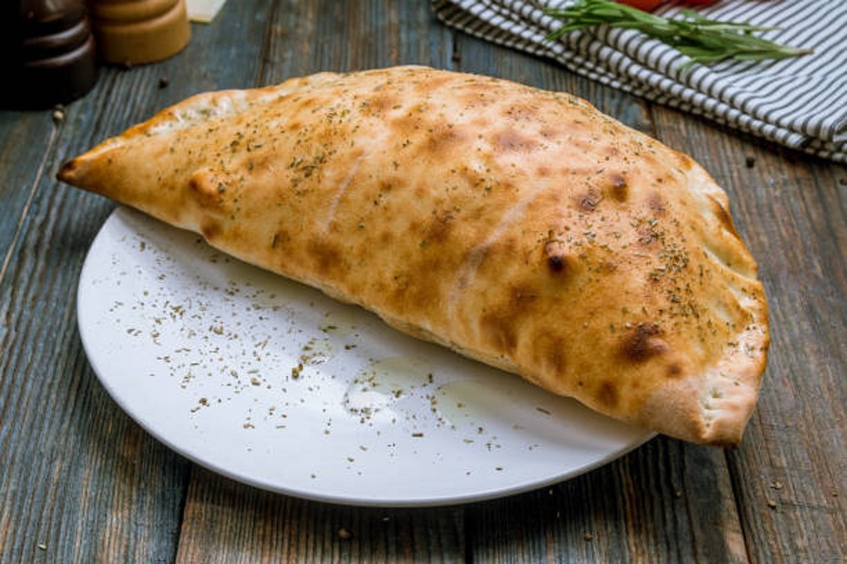 Order Traditional Calzone - Regular food online from Carmine Pizza & Pasta store, Latrobe on bringmethat.com