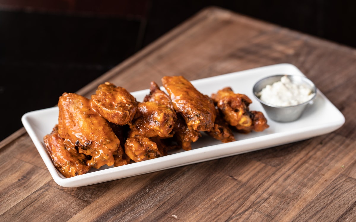 Order TRADITIONAL BONE-IN WINGS - LARGE food online from Gordon Biersch store, New Orleans on bringmethat.com