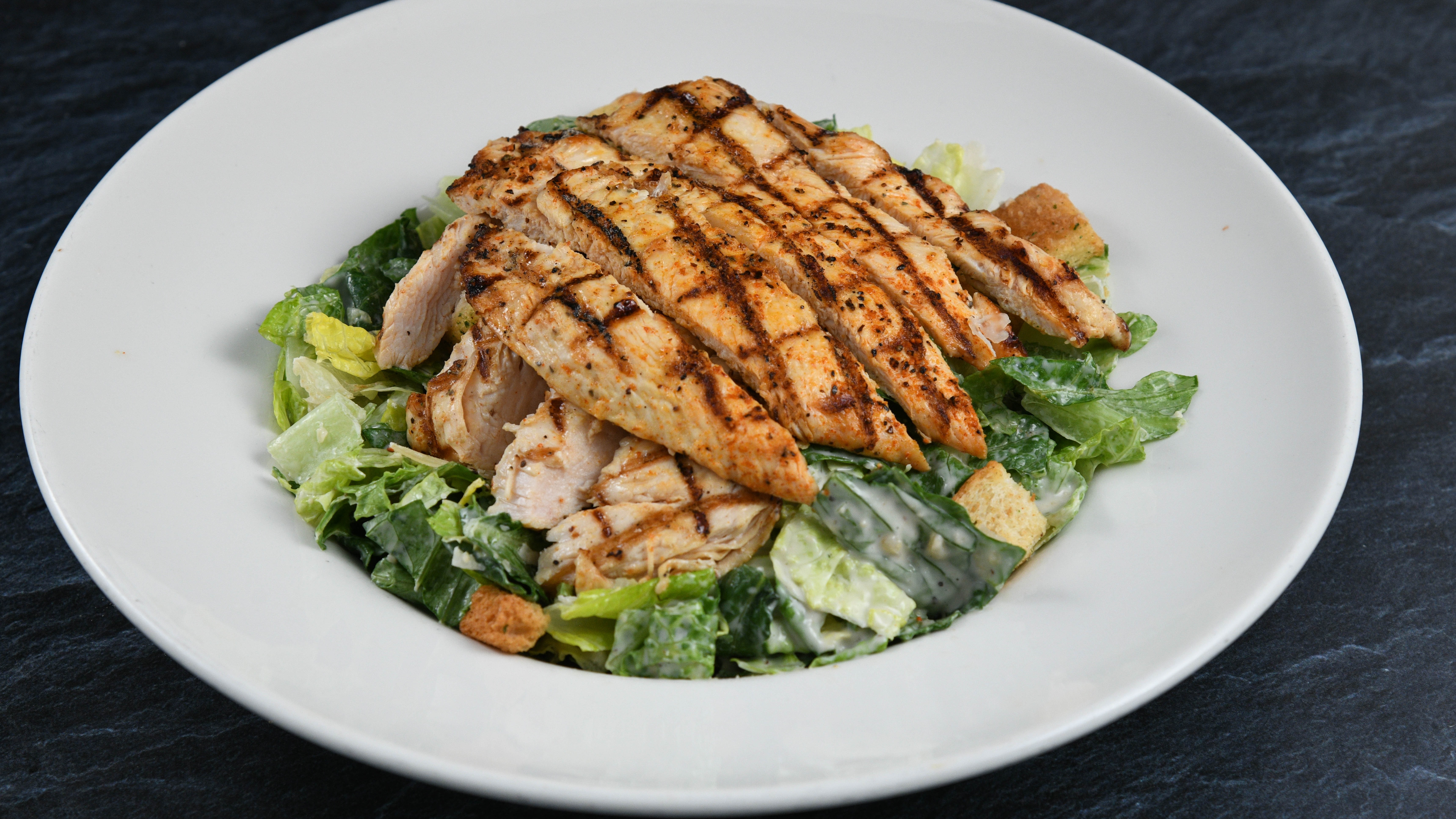 Order Big Islander Caesar Salad with Chicken food online from Rainforest Cafe store, Tempe on bringmethat.com