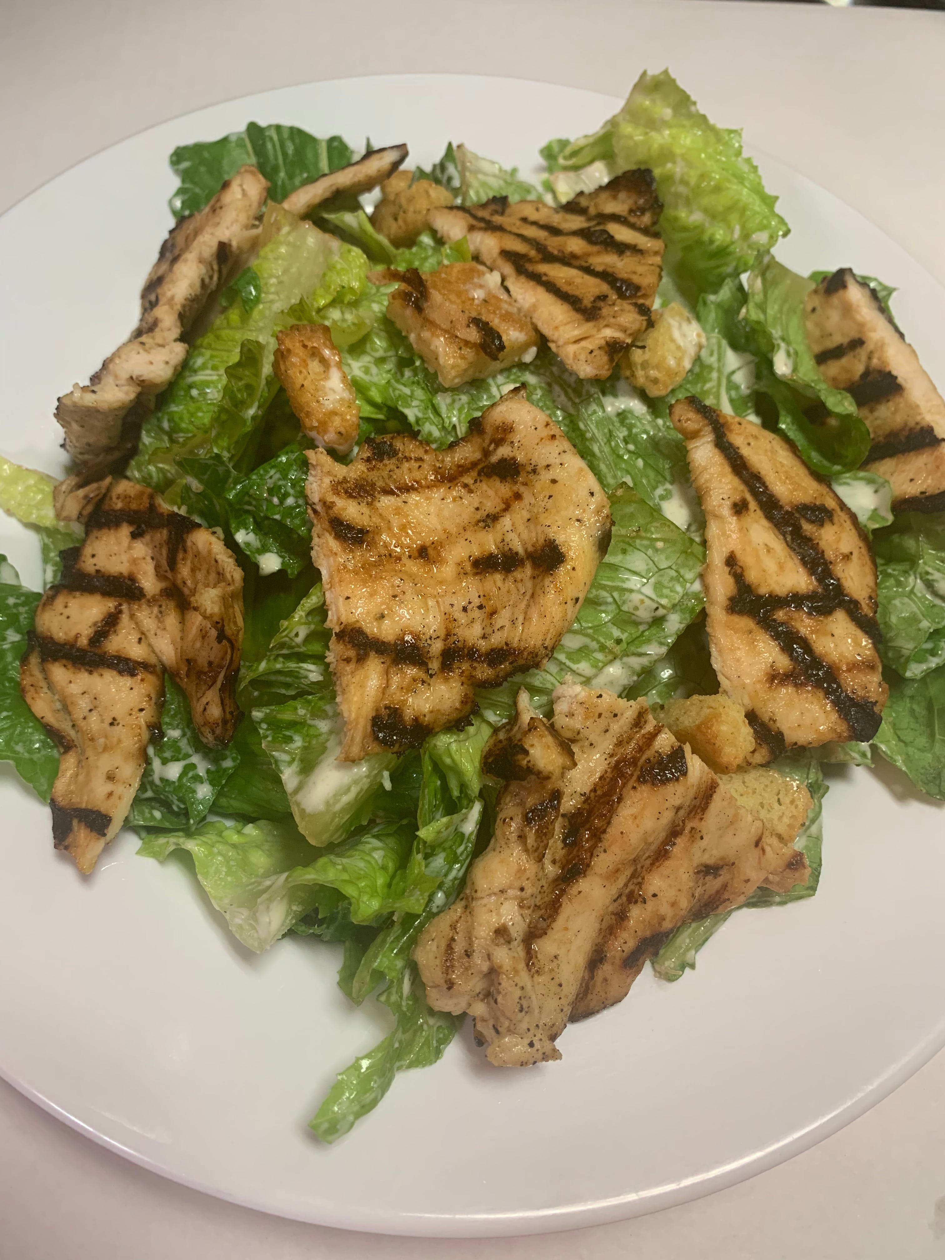 Order Classic Caesar Salad with Grilled Chicken - Salad food online from Taste of Italy Pizzeria store, Corona on bringmethat.com
