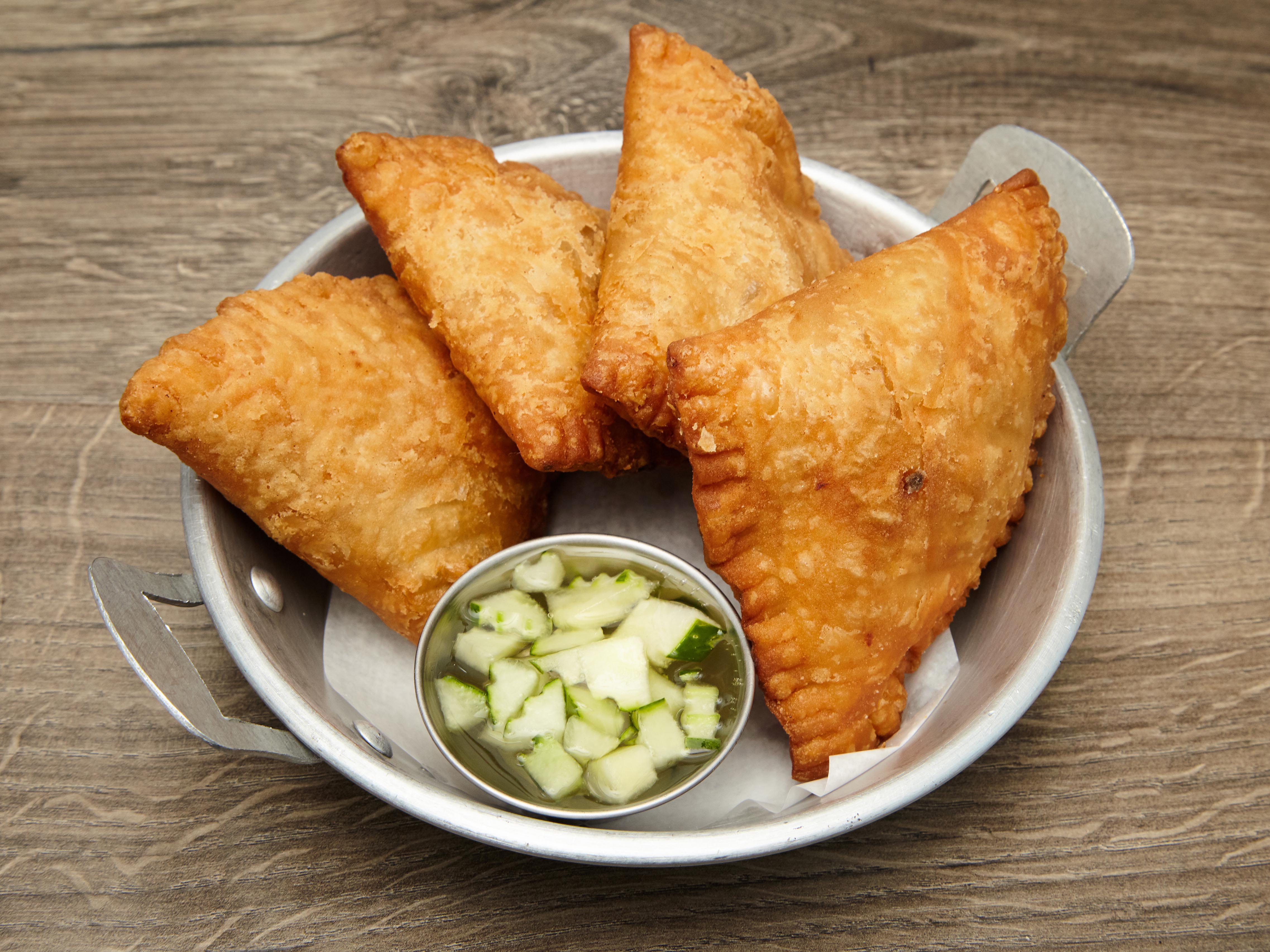 Order A1. Empanadas (Curry puff) 4 pcs. food online from SUROSS Thai Bistro store, New York on bringmethat.com