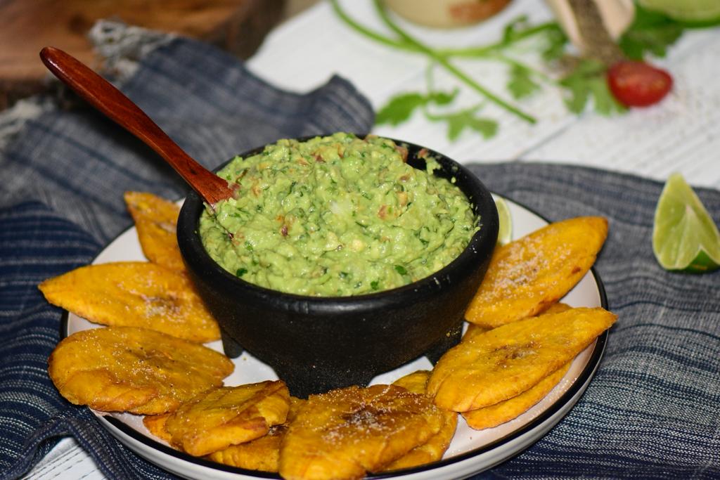 Order Homemade Guacamole with smashed plantain ( tostones ) food online from La Hacienda Restaurant store, Perth Amboy on bringmethat.com
