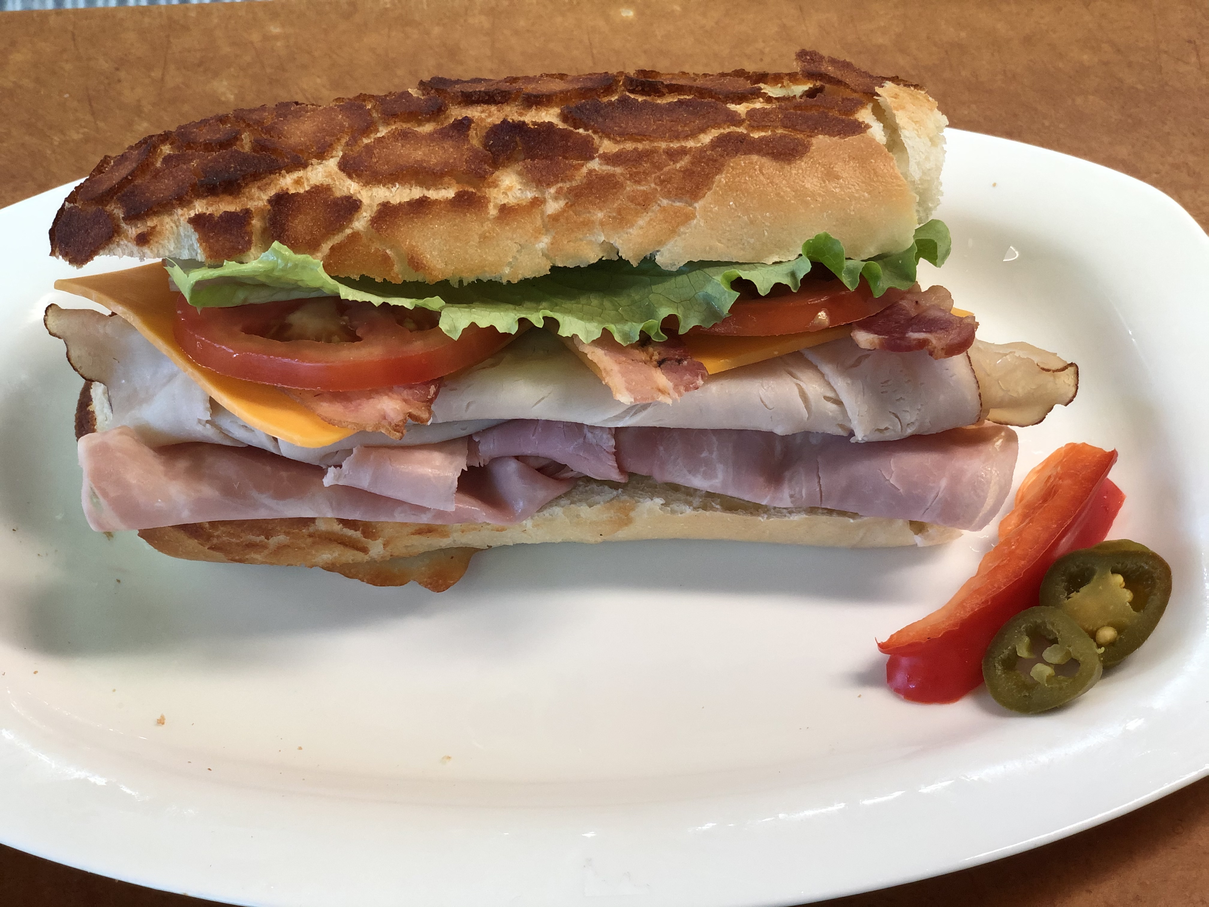 Order Grand Club turkey ham provolone cheese bacon  food online from Lucca Food Deli store, San Francisco on bringmethat.com