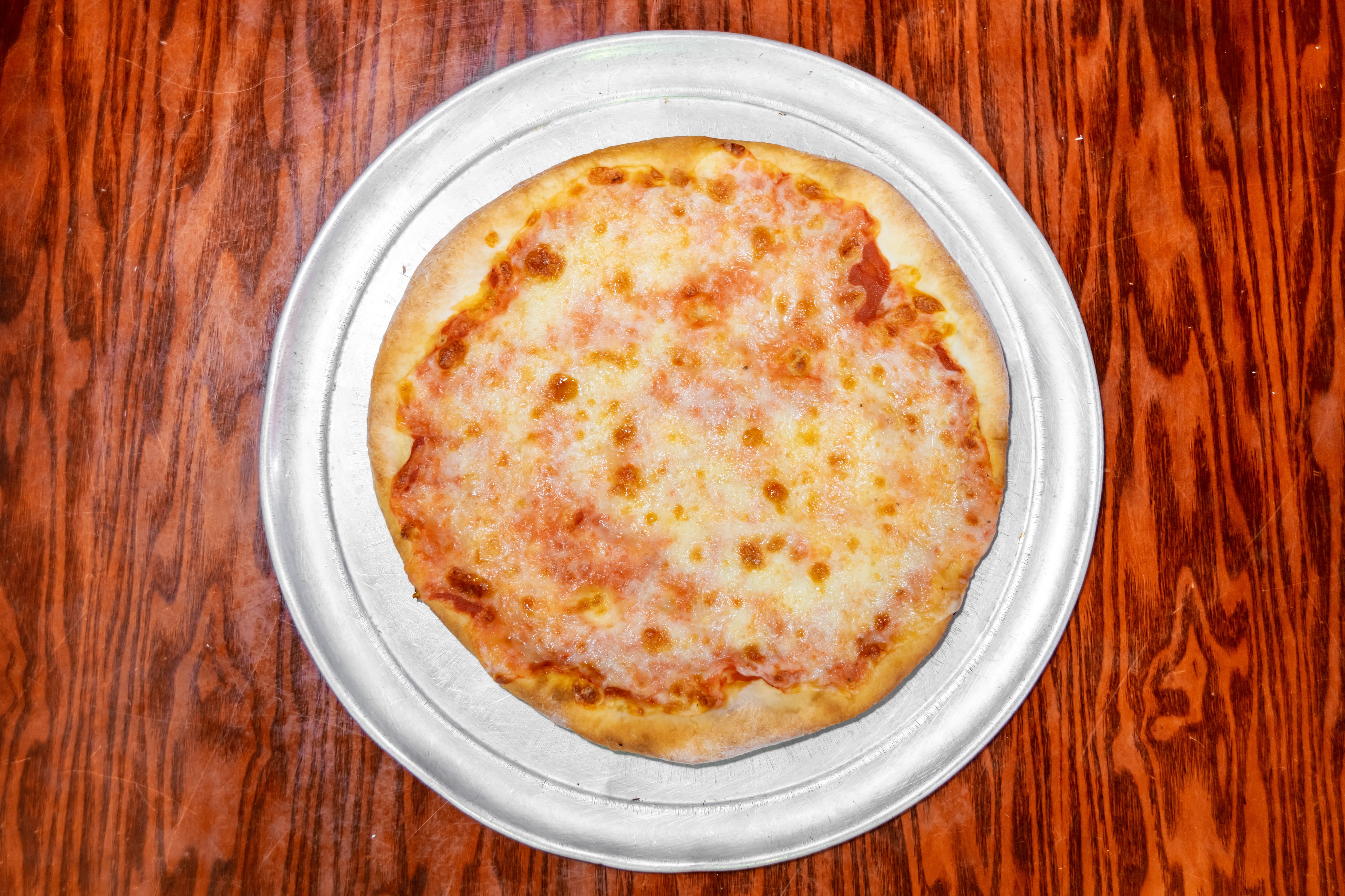 Order Regular Cheese Pizza Slice - Slice food online from Giovannis Pizzeria store, Levittown on bringmethat.com