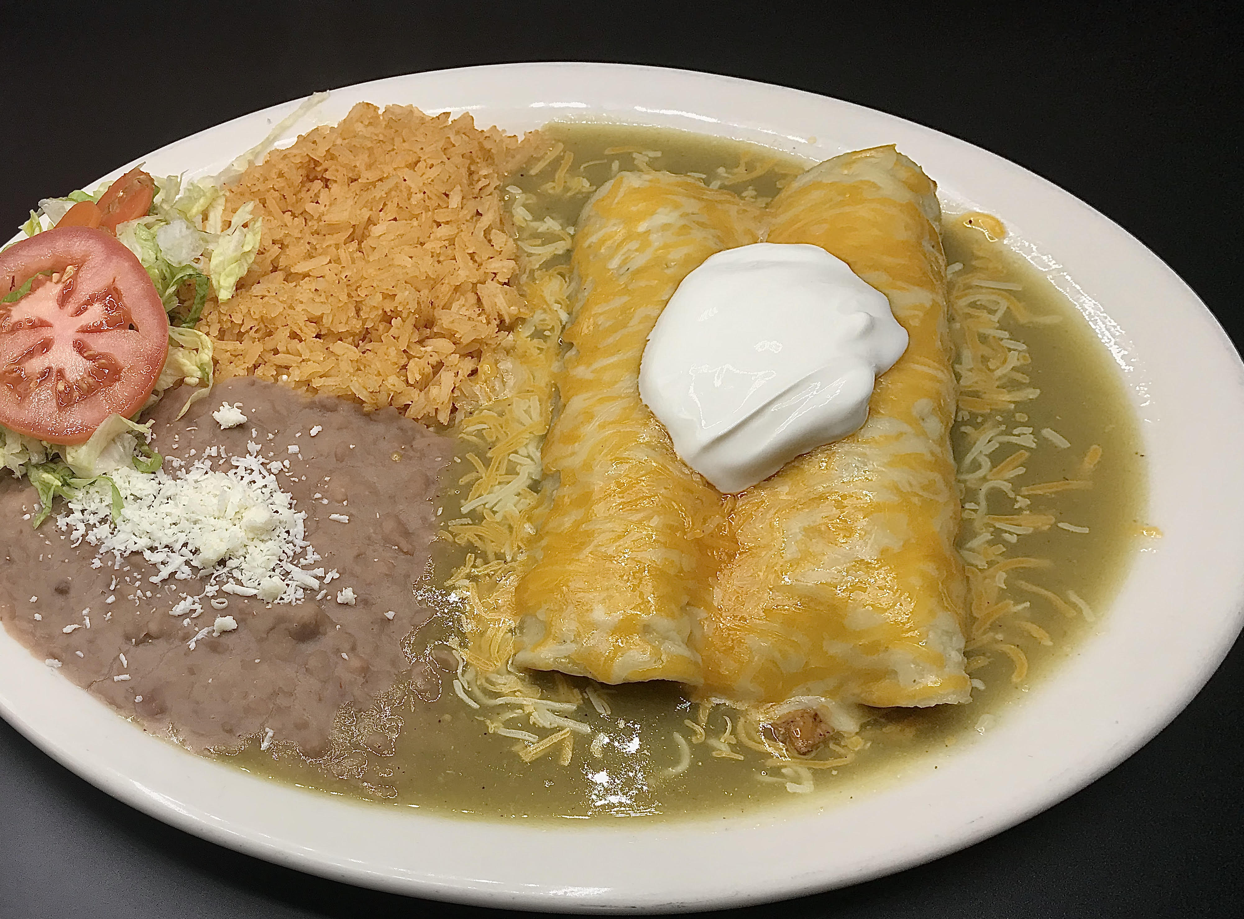 Order 2 Green Sauce Enchiladas with Rice and Beans food online from El Palmar Taqueria Xpress store, Merced on bringmethat.com