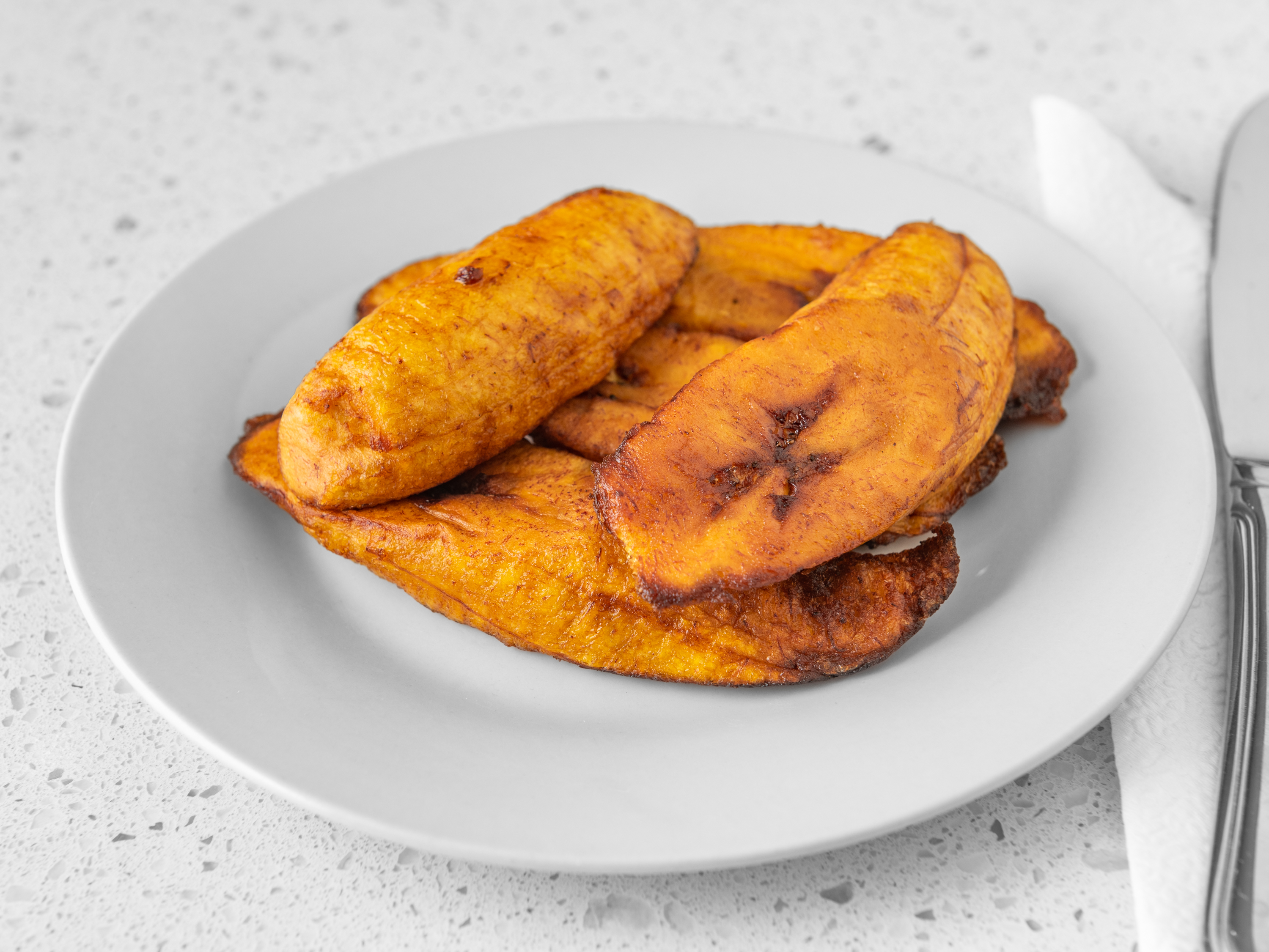 Order 7 Piece Fried Plantain food online from Aunty Joy's Jamaican Kitchen store, Chicago on bringmethat.com