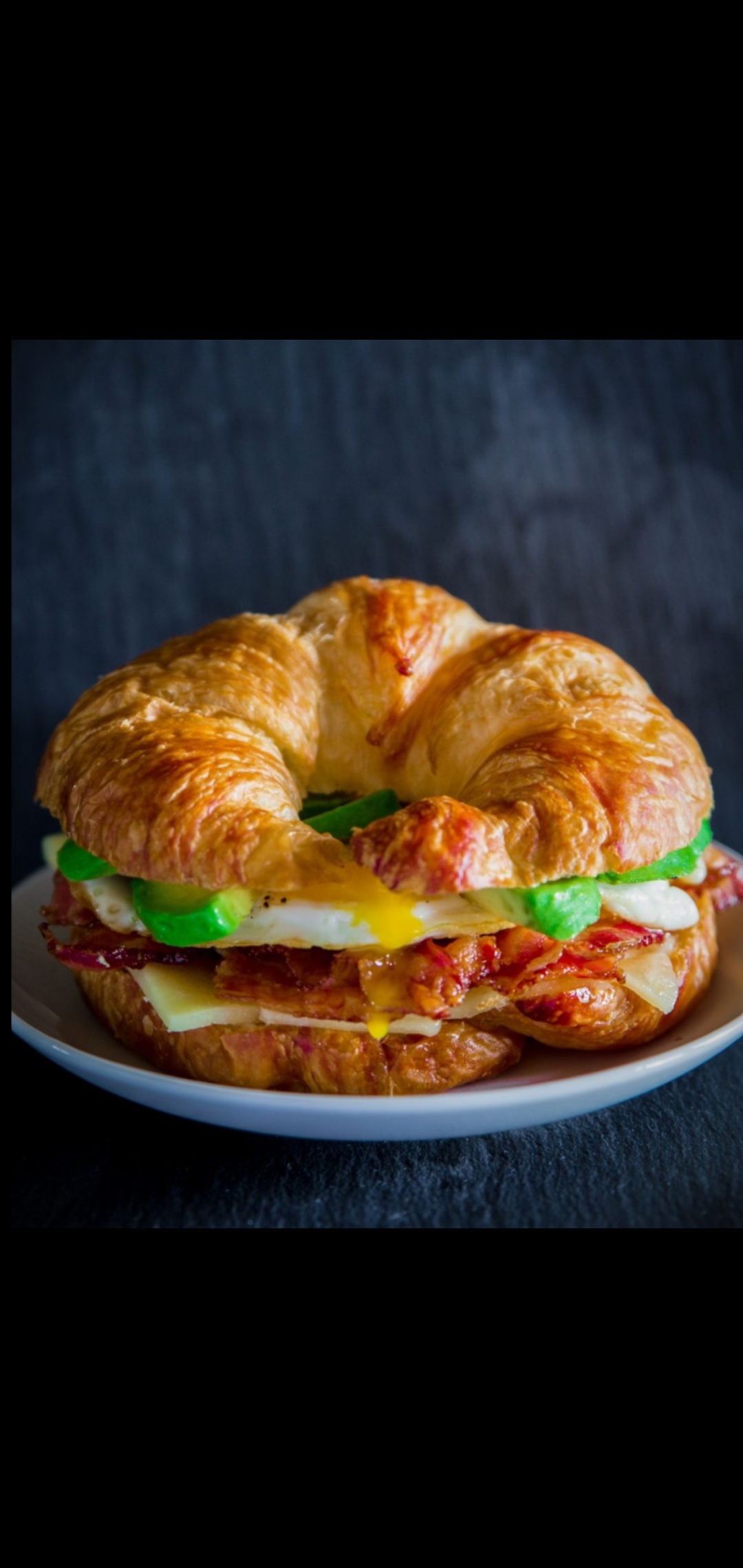 Order Four Egg Whites With Avocado Bacon And Melted Cheese Croissant  food online from American Gourmet Foods Deli store, New York on bringmethat.com