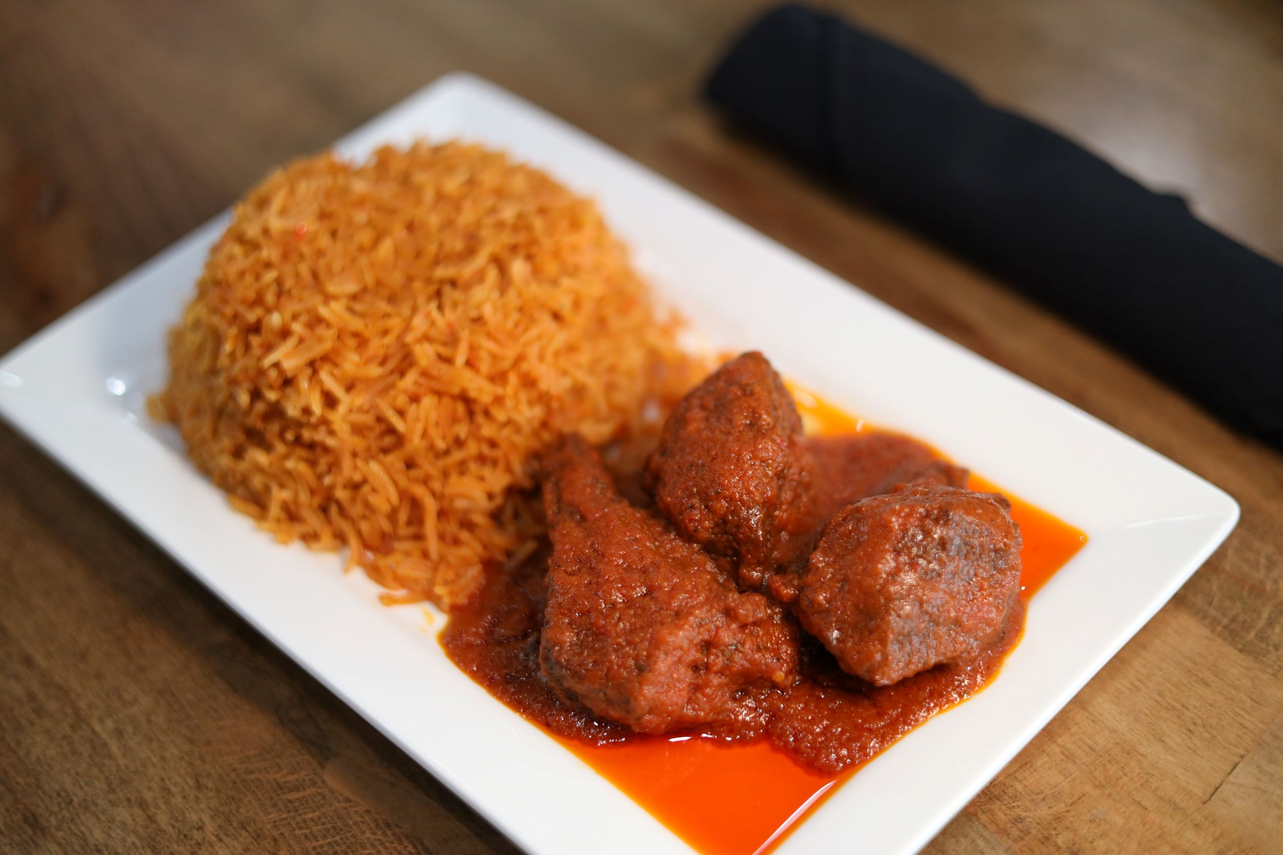 Order Jollof Rice and Stew Beef food online from Fusion Vibes Kitchen + Bar store, Richardson on bringmethat.com