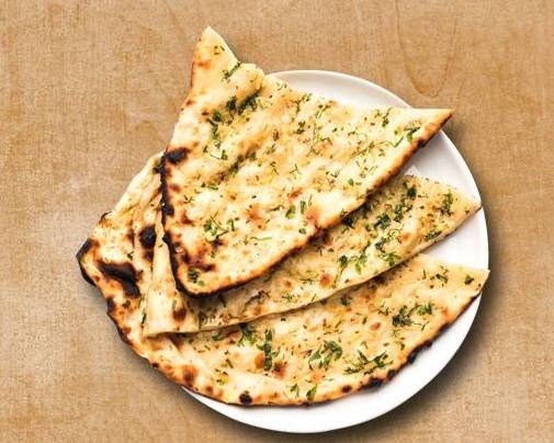 Order Garlic Naan food online from Curry Consortium store, Topeka on bringmethat.com