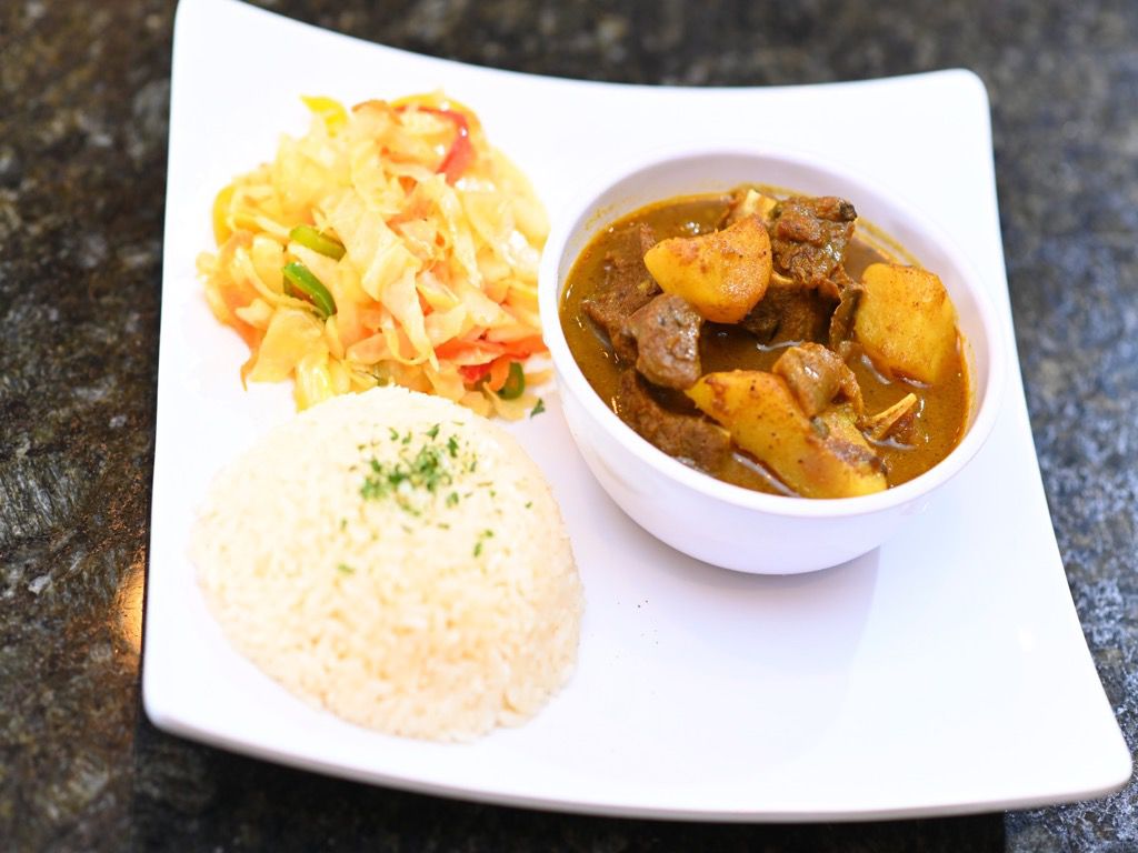 Order Curry Goat food online from Cafe 214 store, Addison on bringmethat.com