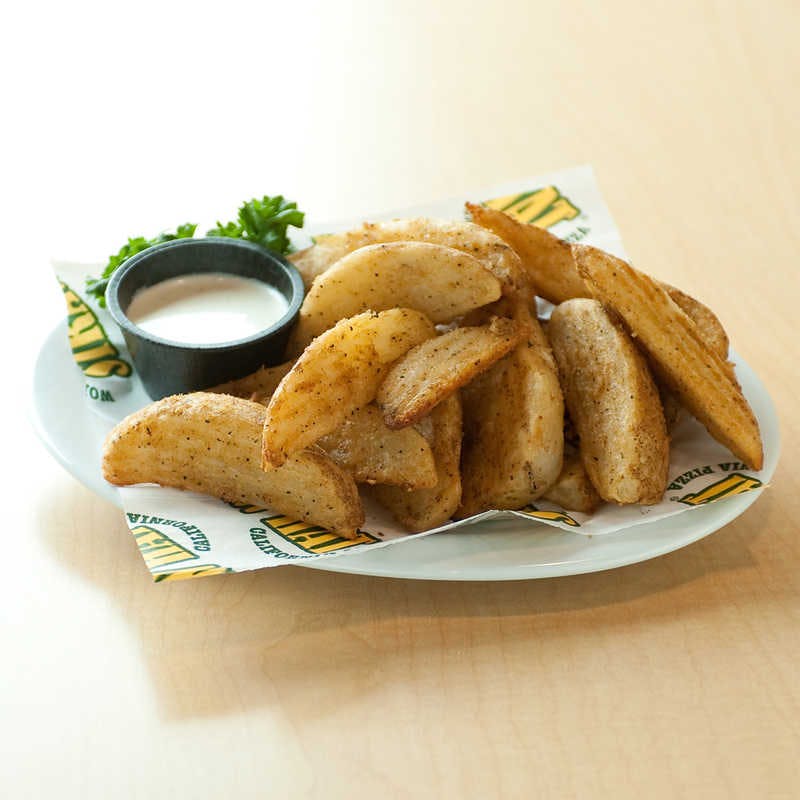 Order Seasoned Potato Wedges - 1 lb. food online from Straw Hat Pizza Grille store, Milpitas on bringmethat.com