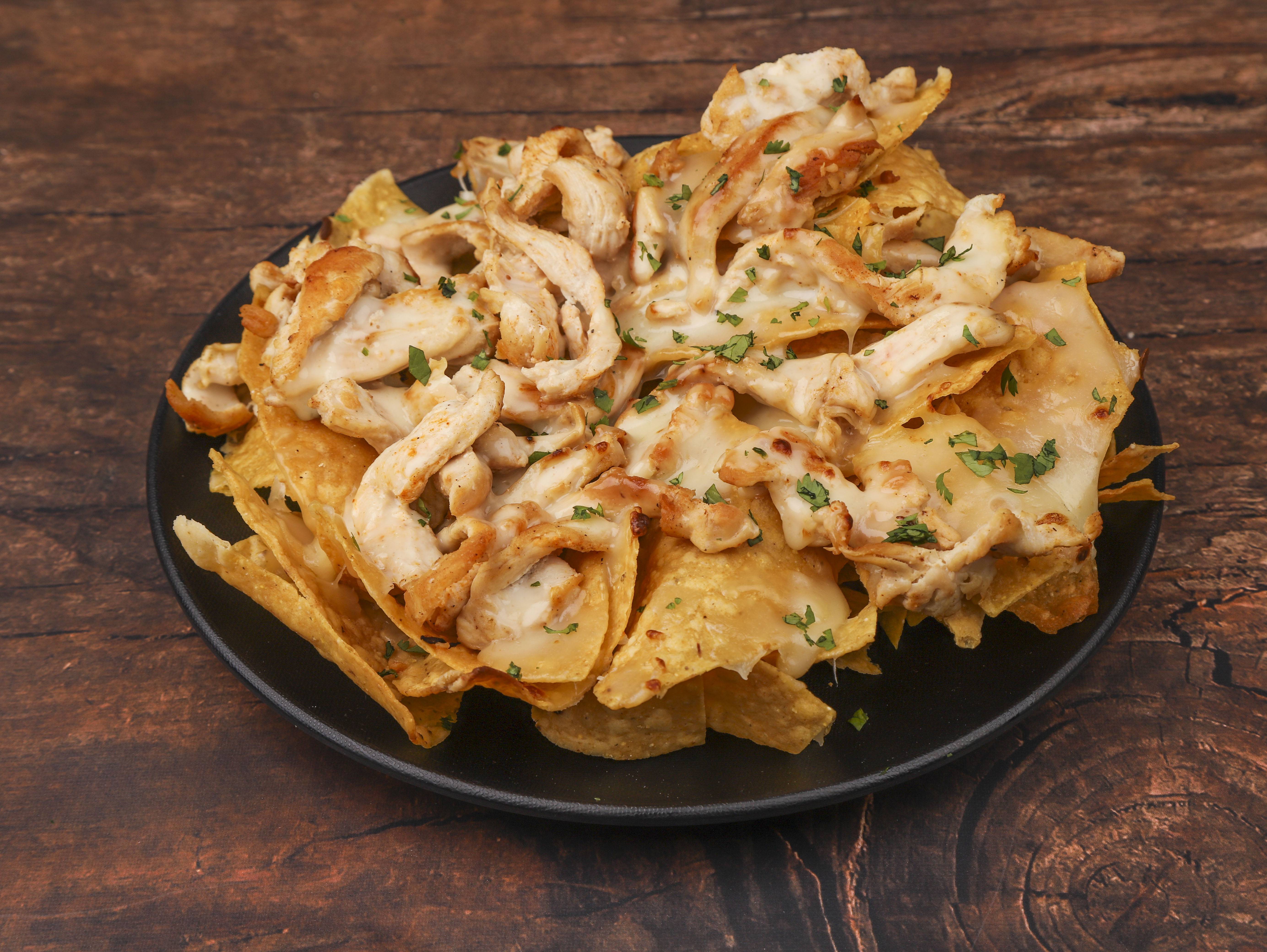 Order Grilled Chicken Nachos food online from La Carreta Mexican Restaurant store, Raleigh on bringmethat.com