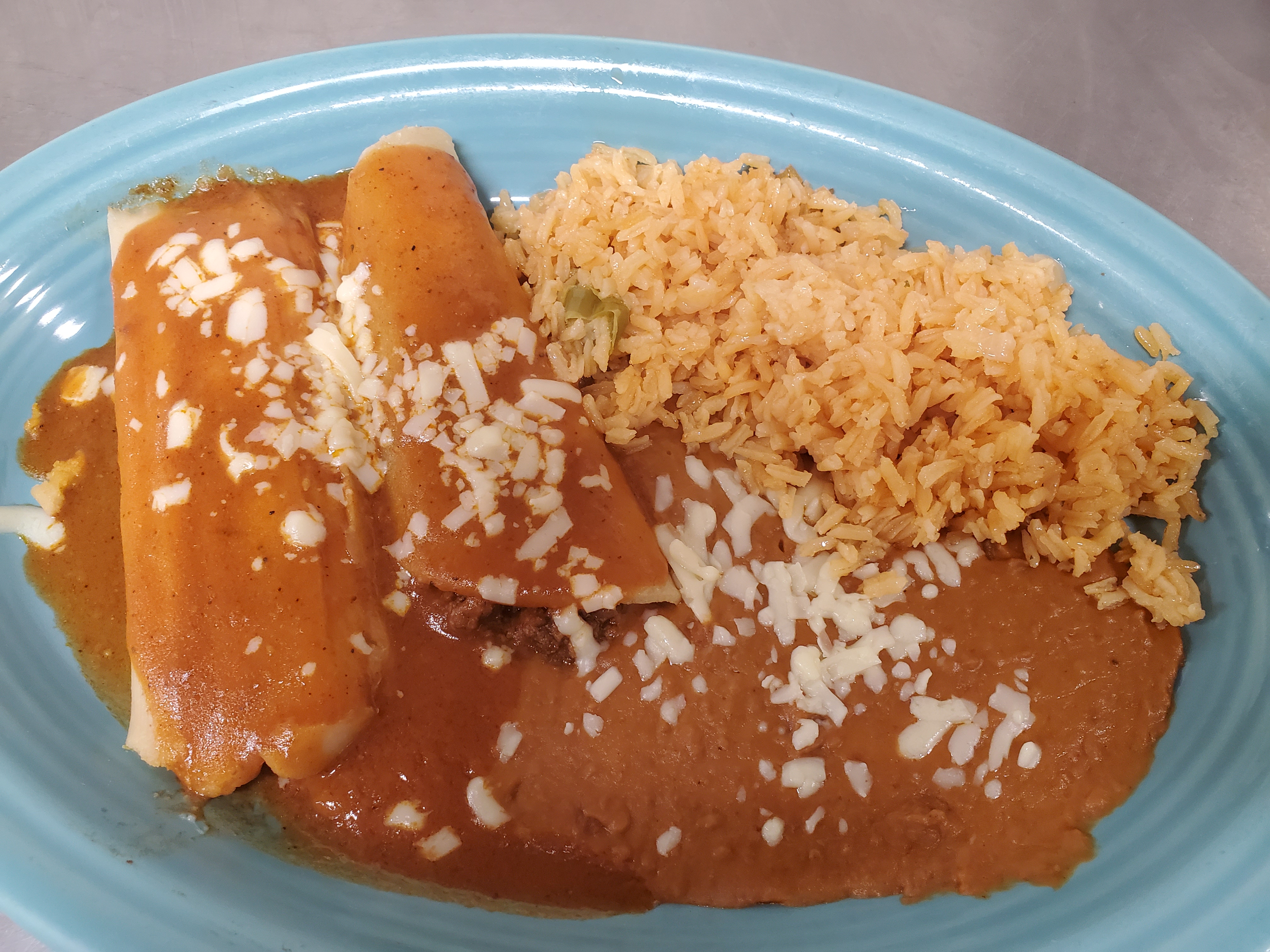 Order  8. Beef Enchilada, Tamale, Rice & Beans food online from Los Gallos Mexican Grill store, Rochester on bringmethat.com