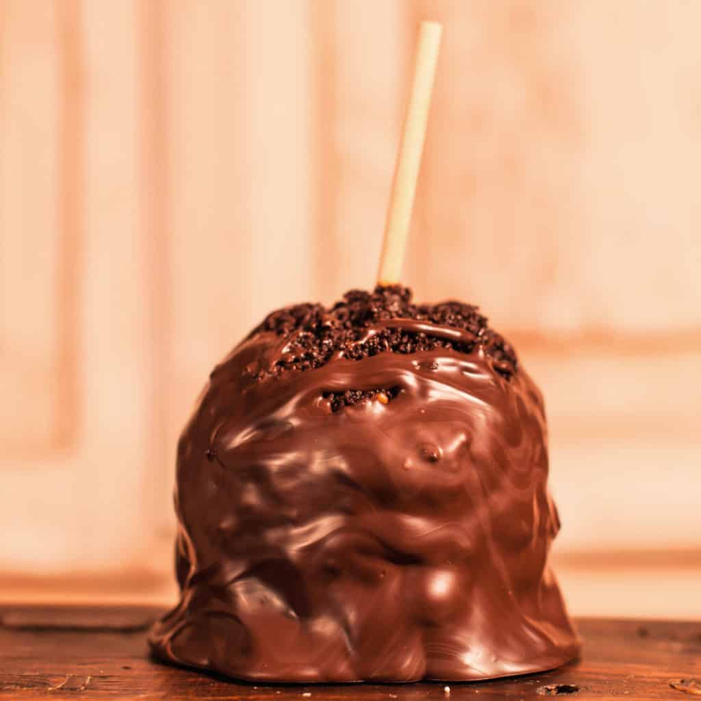 Order Cake Crunch Caramel Apple With Dark Chocolate food online from Candy Apple Shoppe store, Glenwood on bringmethat.com