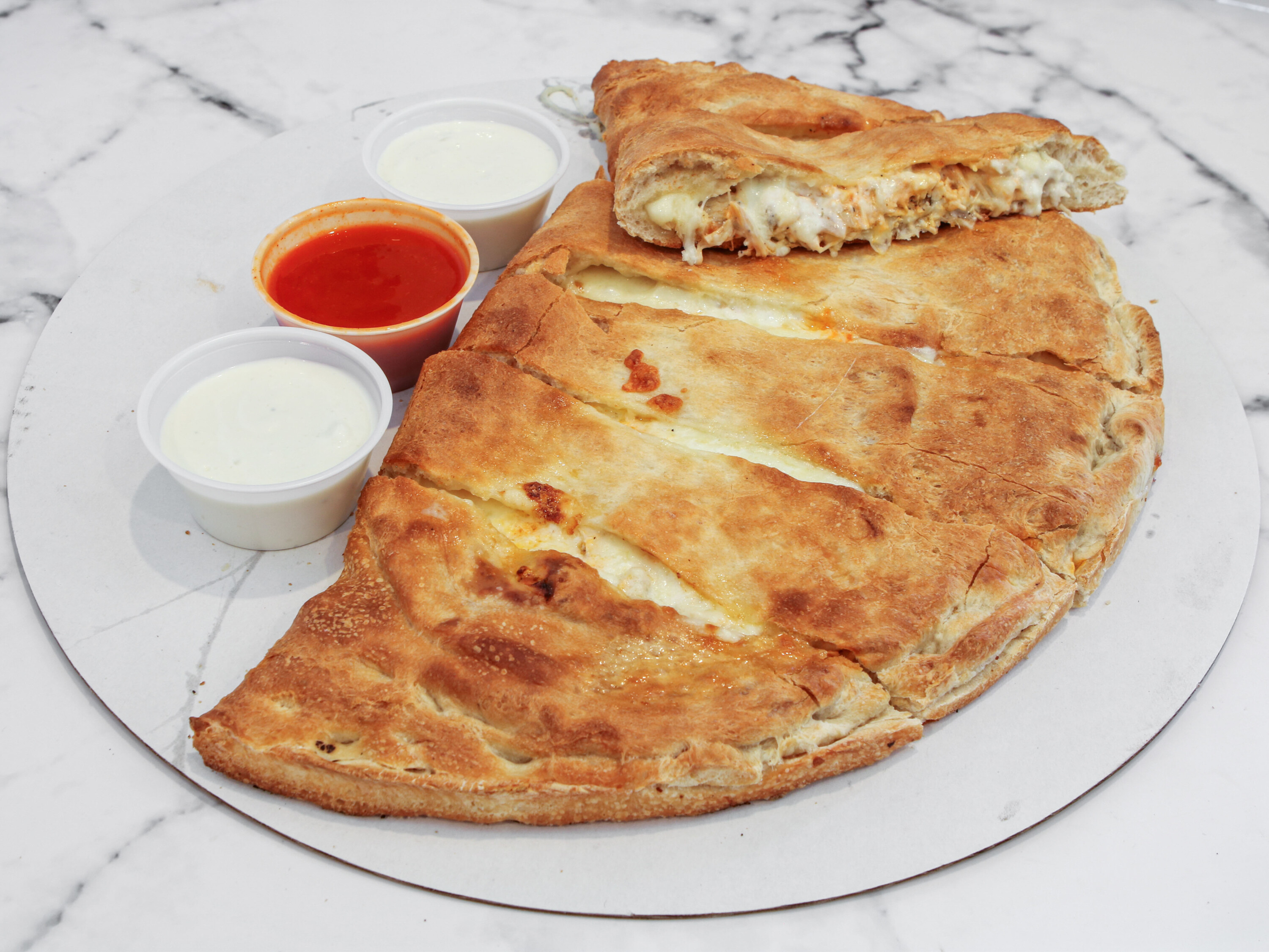 Order Buffalo Calzone food online from Yovanis Pizzeria store, Cumberland on bringmethat.com