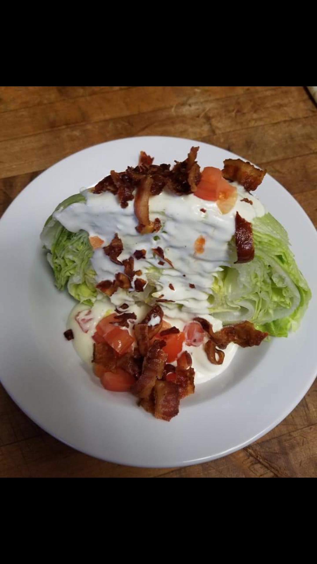 Order Iceburg Blue Cheese Tomato Wedge Salad food online from Minervas Pizza store, Providence on bringmethat.com