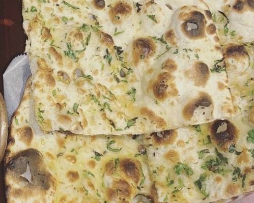 Order Garlic Naan food online from Flavors Of India store, Gilbert on bringmethat.com