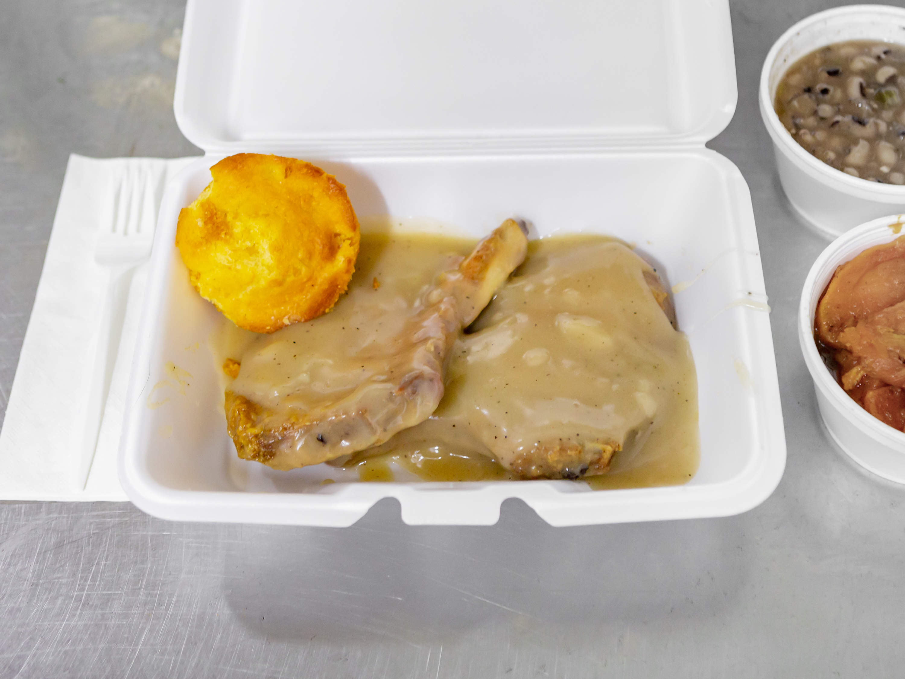 Order Smothered Pork Chop  food online from Uptown BBQ & Soulfood store, Detroit on bringmethat.com