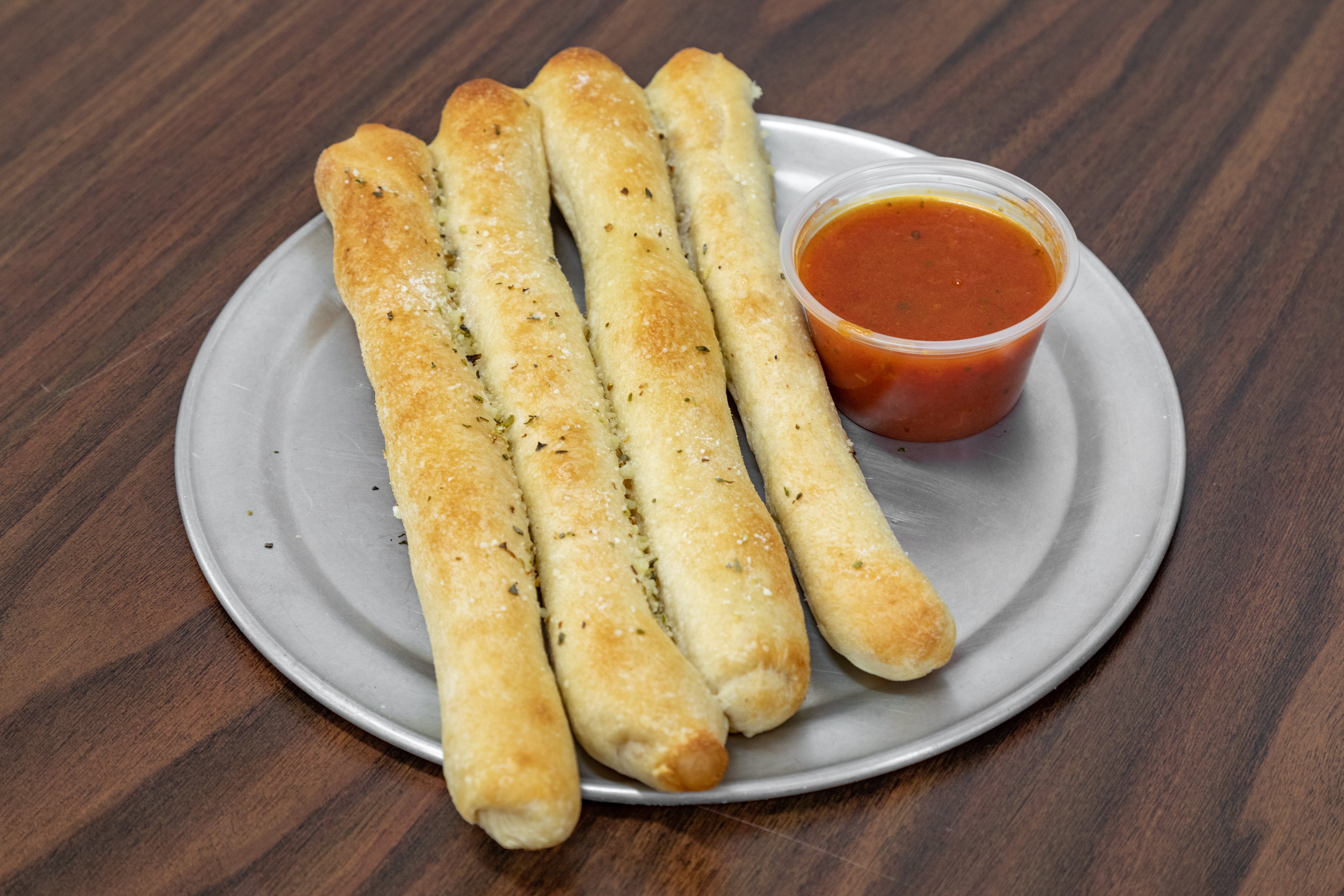 Order Plain Breadsticks - 4 Pieces food online from Pronta Pizzeria store, Indianapolis on bringmethat.com
