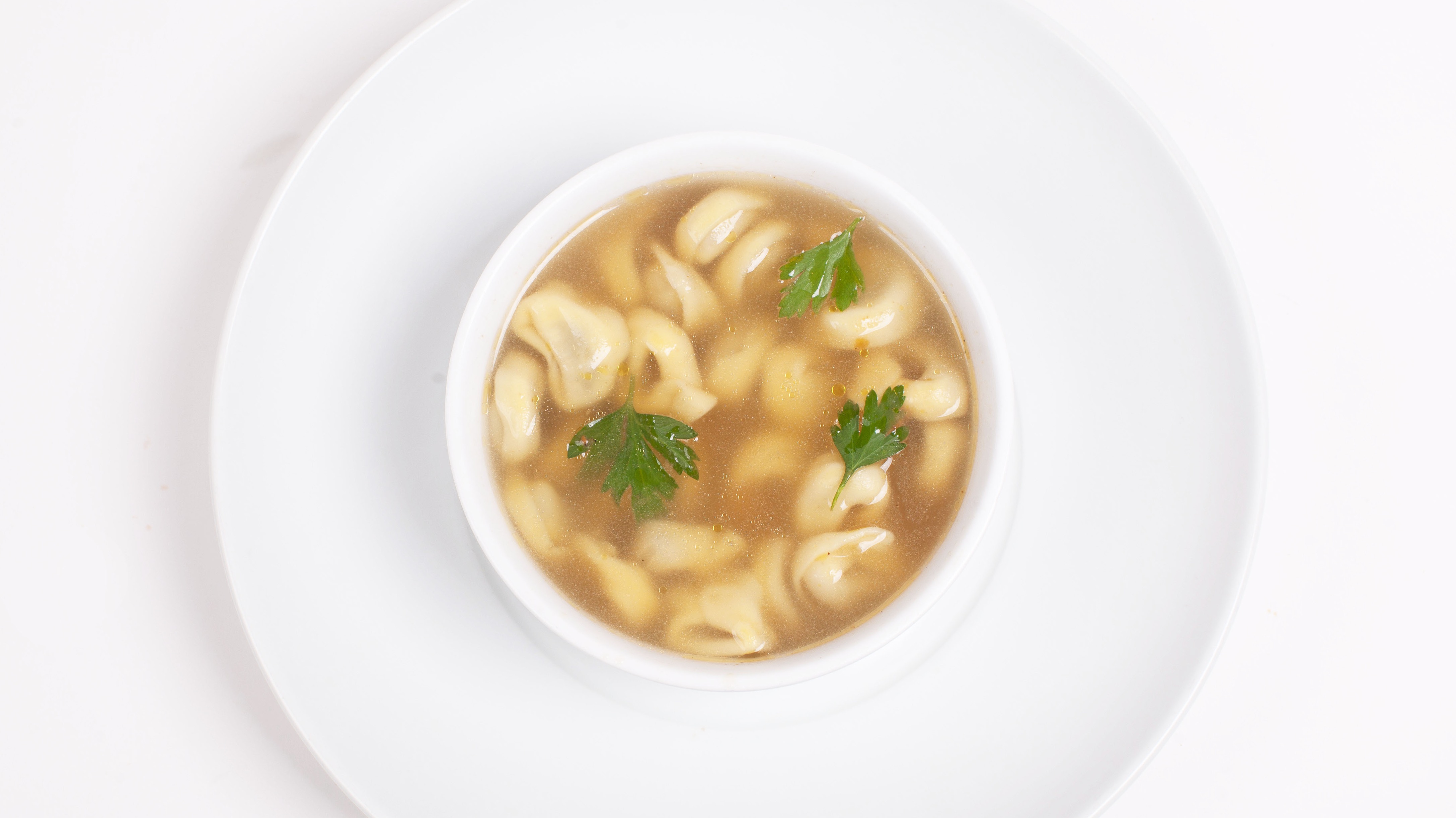 Order Tortellini in Brodo food online from Umberto's Pizzeria store, New Hyde Park on bringmethat.com