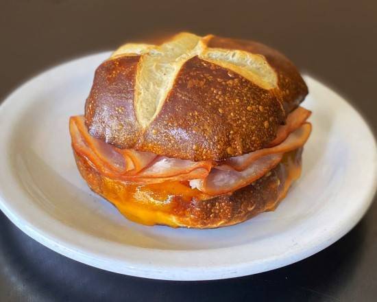 Order Pretzel Bun Sandwich - Turkey and Cheese food online from Sweetwaters Coffee & Tea Monroe North store, Grand Rapids on bringmethat.com
