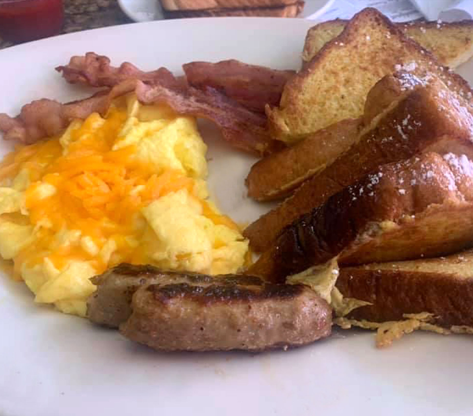 Order 3 Thick Sliced French Toast - with 2 Eggs, 2 Bacon Strips & 2 Sausage Links food online from Pinocchio In The Desert store, Palm Springs on bringmethat.com