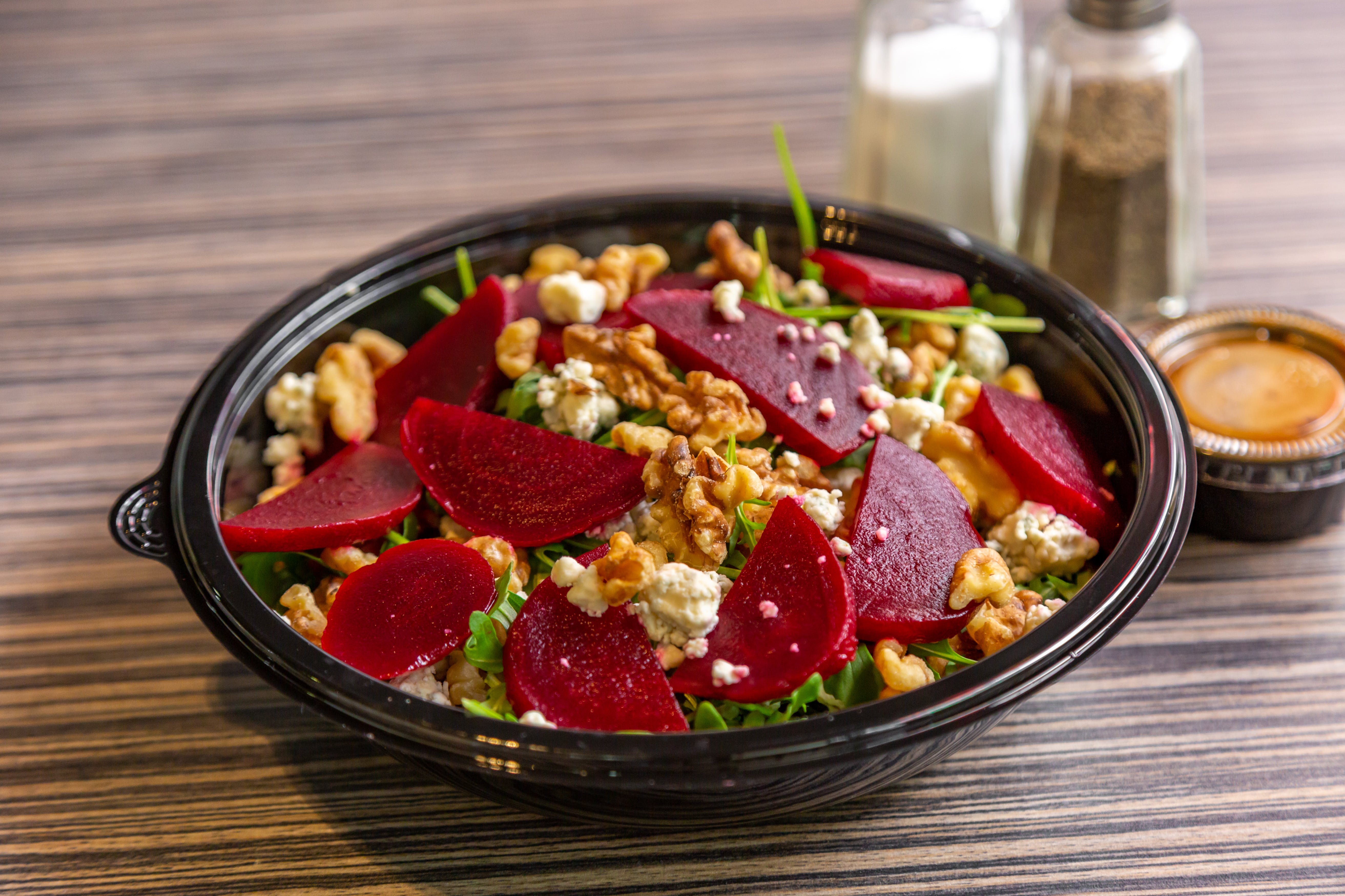 Order Arugula & Beet Salad - Salad food online from Art of Pizza on State Street store, Chicago on bringmethat.com