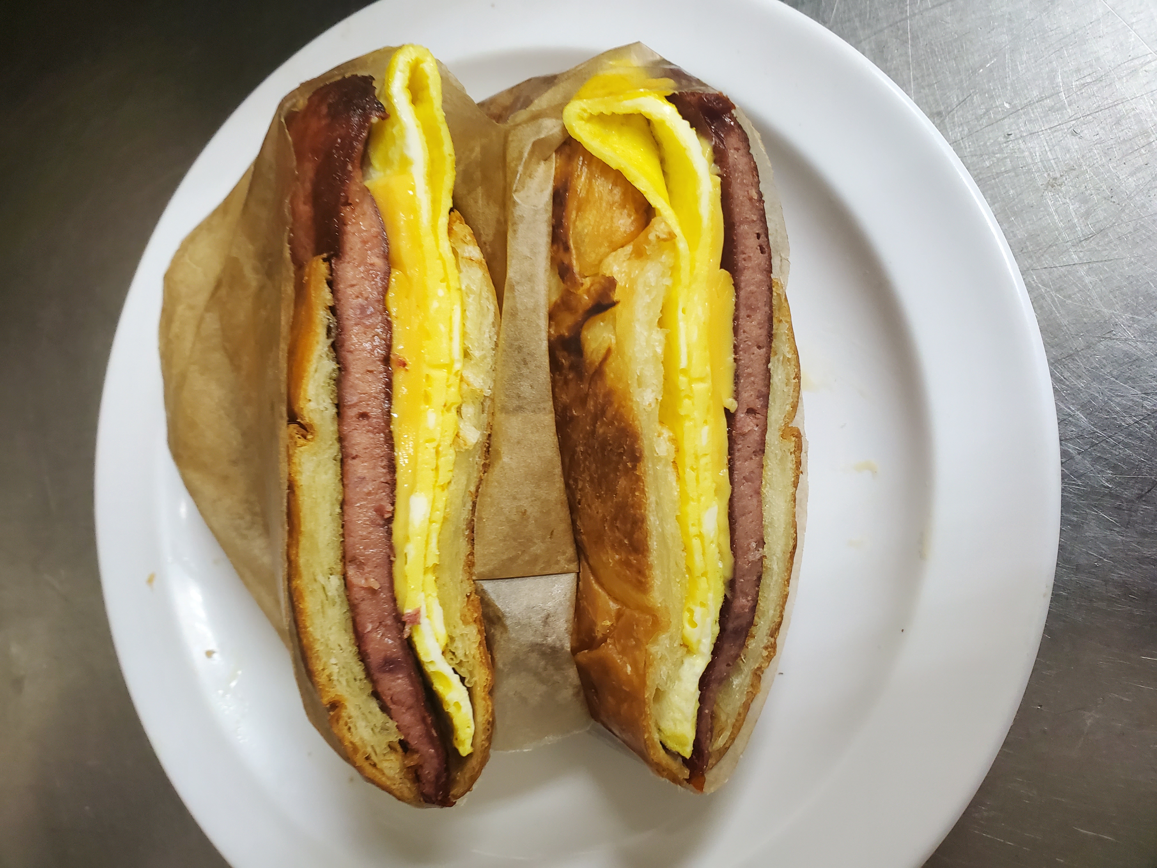Order beef sausage egg & cheese on roll food online from Aminas Cafe store, Bronx on bringmethat.com