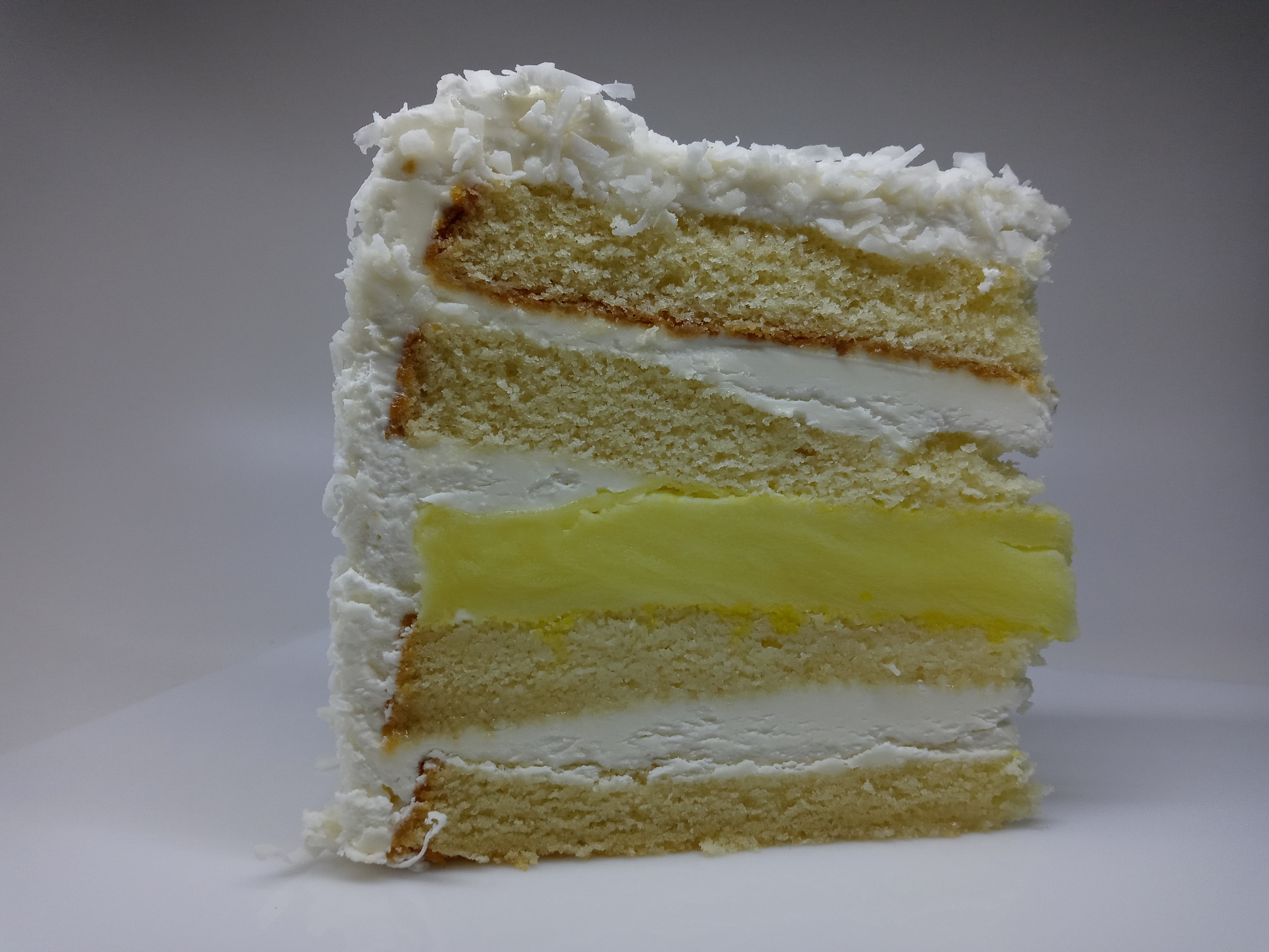 Order COCONUT LEMON CAKE food online from Wholesome Factory store, New York on bringmethat.com
