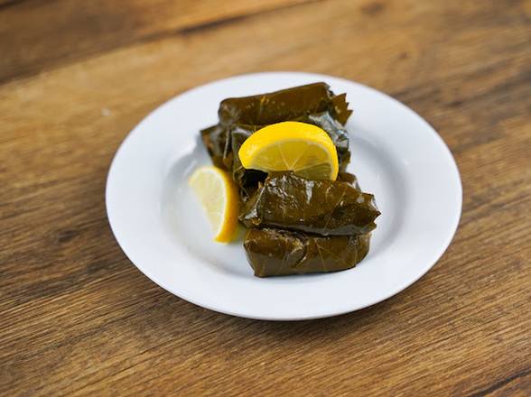 Order Veggie Grape Leaves - 4 pieces food online from Dimassi's Mediterranean Kitchen store, Humble on bringmethat.com
