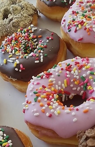 Order Iced Donut with Sprinkles food online from Leo Bakery store, Las Cruces on bringmethat.com