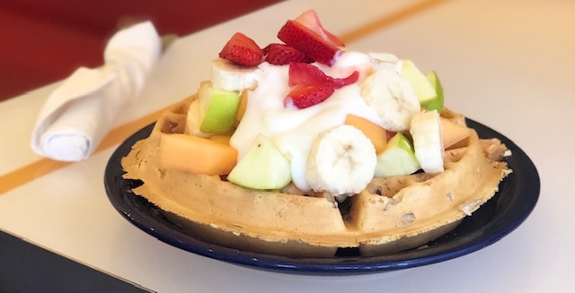 Order The Golden waffle topped w/ Fresh Fruit & yogurt food online from Cafe 222 store, San Diego on bringmethat.com