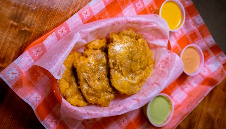 Order Fried green plantains/Tostones food online from Quechua's Peruvian Rotisserie Chicken and Cuisine store, Camp Hill on bringmethat.com