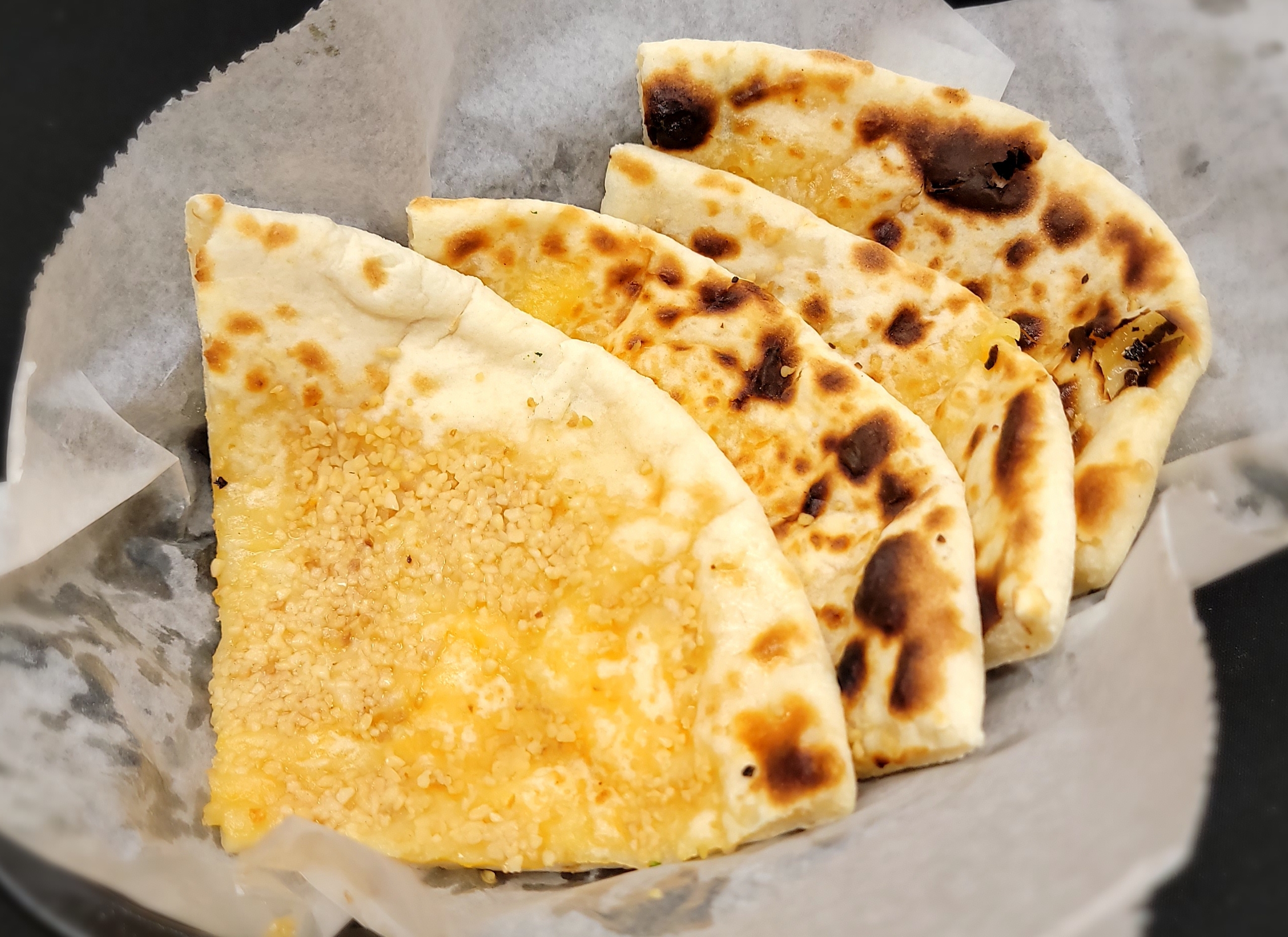 Order Garlic Cheese Naan food online from Little India Restaurant & Bar store, Denver on bringmethat.com