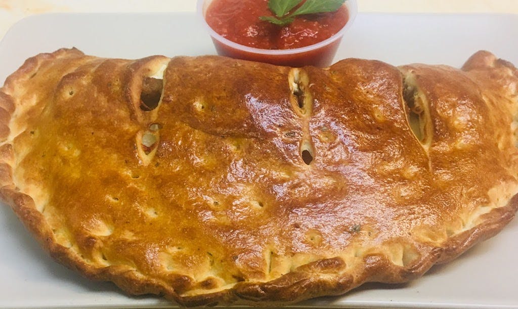 Order Meat Lovers Calzone - Calzone food online from Listrani's store, McLean on bringmethat.com