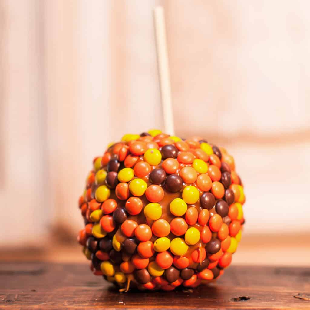 Order Reese’s Pieces®Caramel Apple food online from Candy Apple Shoppe store, Glenwood on bringmethat.com