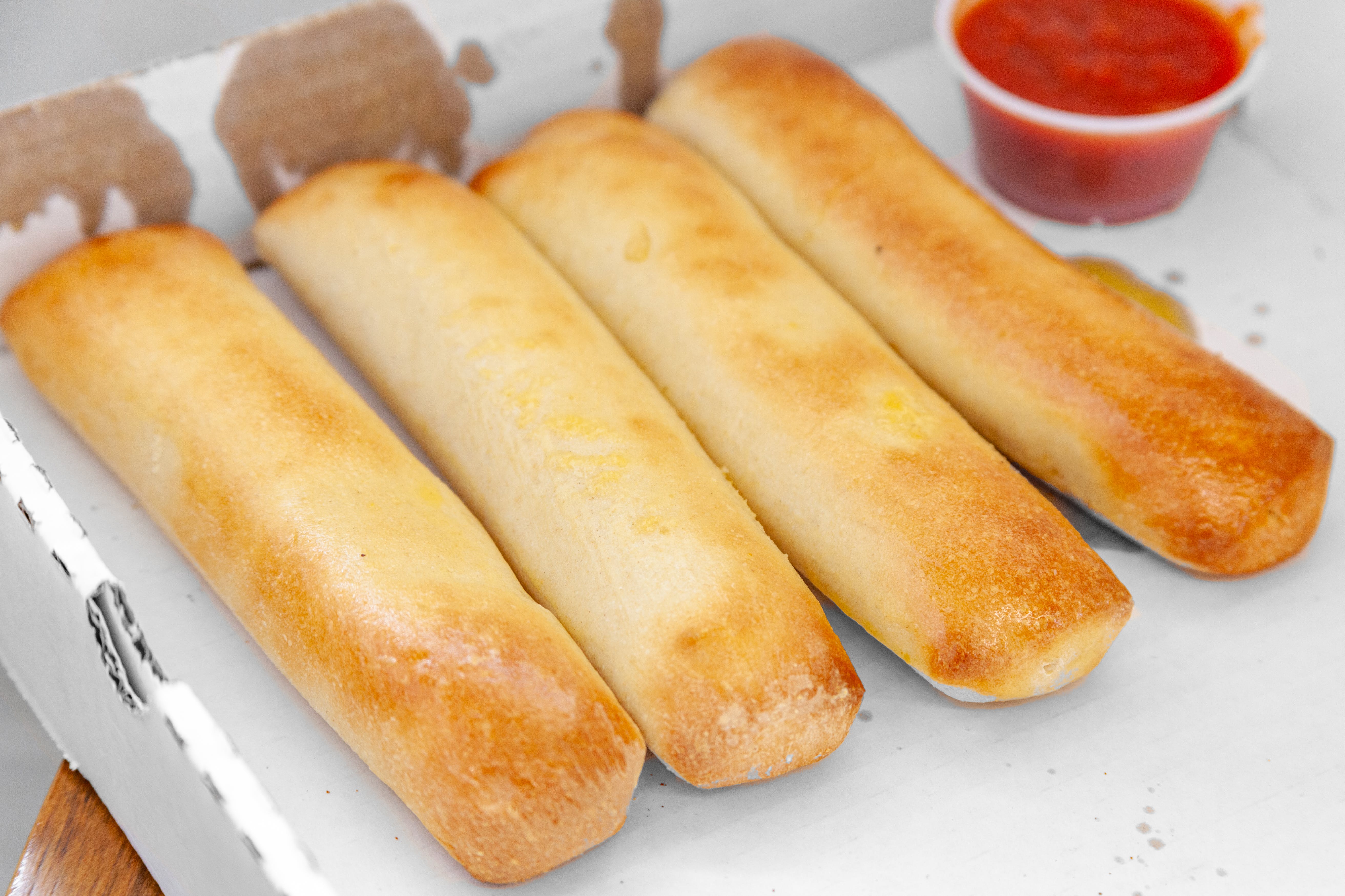 Order Breadsticks with Cheese & Sauce - 4 Pieces food online from Gianni Pizza & Italian Ristorante store, Hillsboro on bringmethat.com